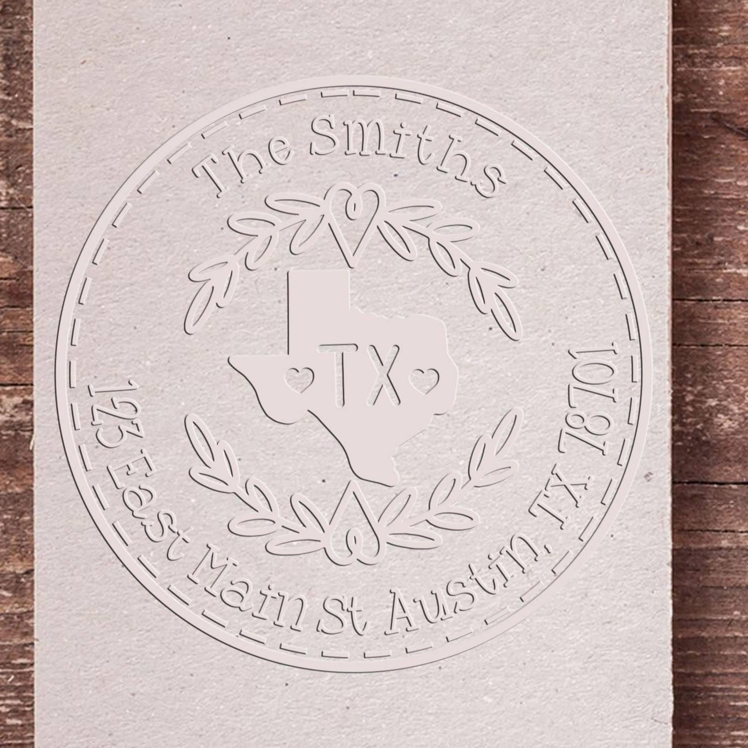 Custom white embossed circular stamp seal with Texas outline, laurel wreath, heart, and The Smiths address.