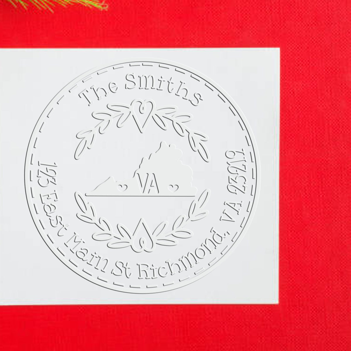 White embossed custom seal stamp for The Smiths, with laurel wreath and Richmond, VA address on a red background.
