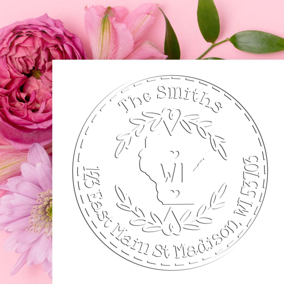 Pink floral background with circular custom stamp seal for The Smiths, featuring engraved leaves and map outline.