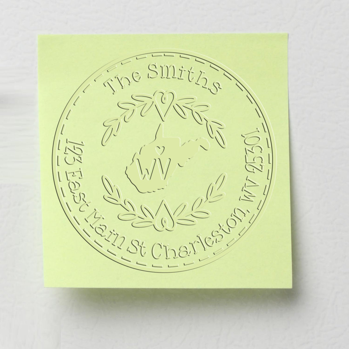 Pale lime green embossed stamp seal for The Smiths, with circular wreath logo and Charleston, WV address.