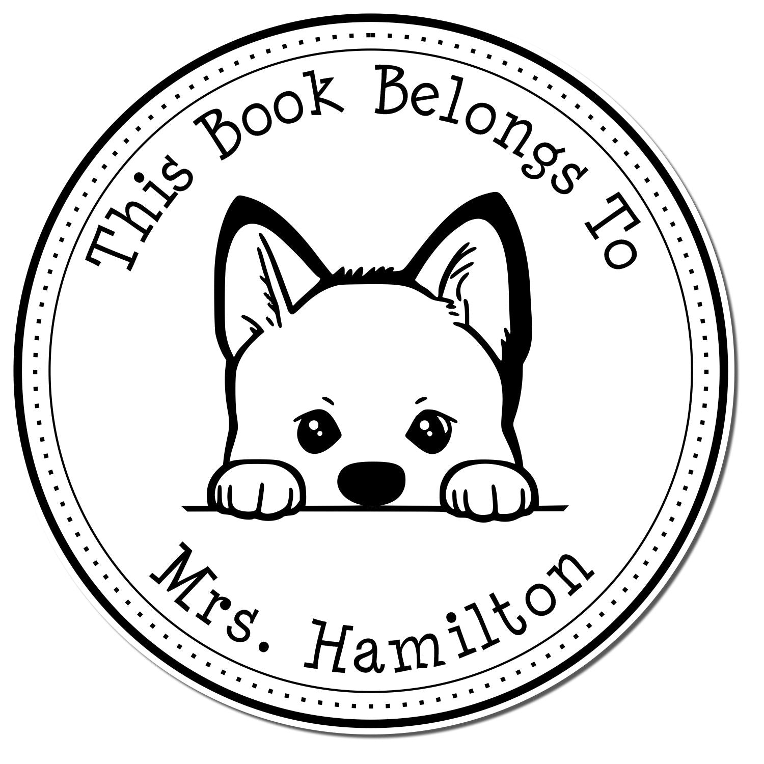 Black-and-white circular book stamp seal with a puppy peeking over a line and text: This Book Belongs To Mrs. Hamilton.