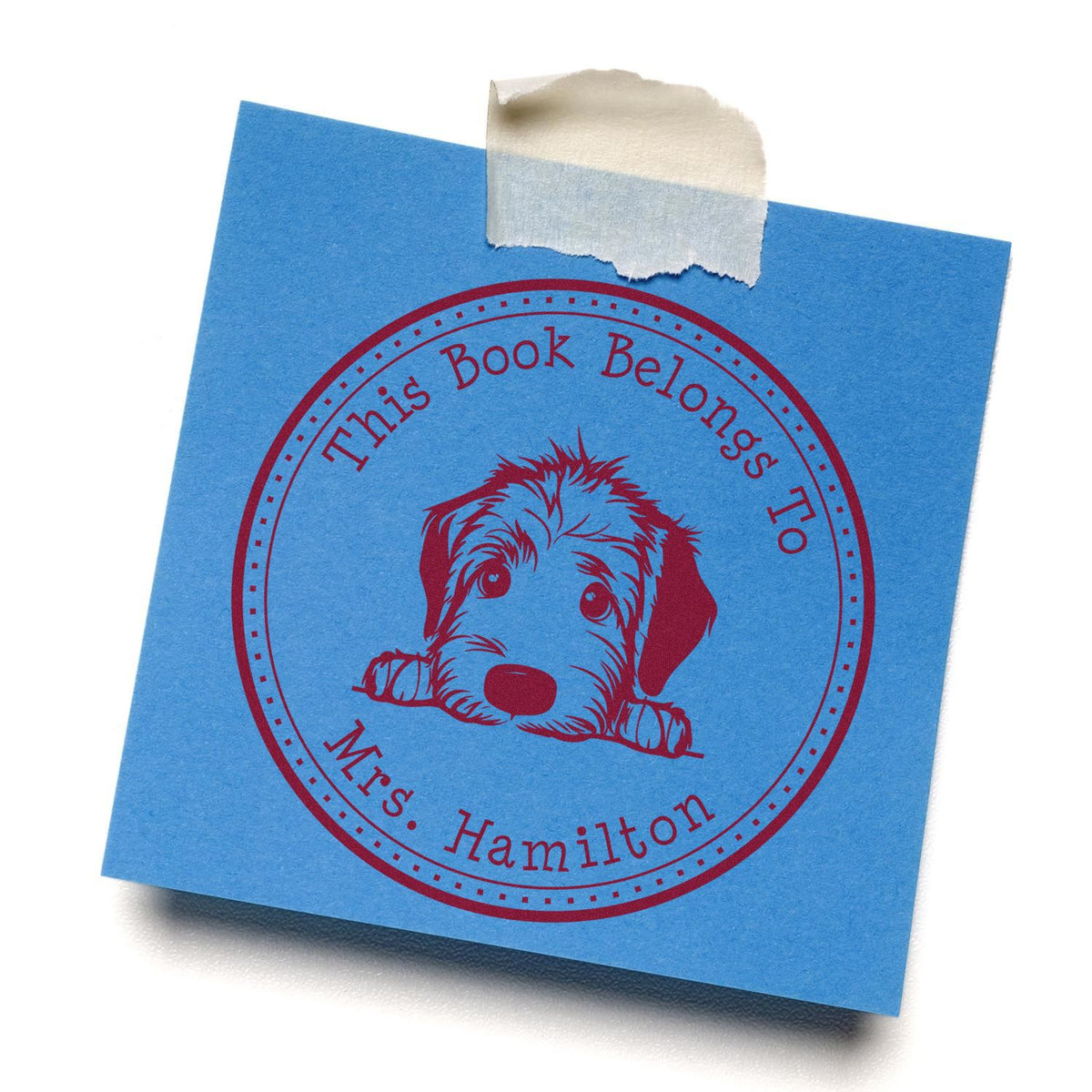 Blue book plate stamp seal with red puppy and This Book Belongs To Mrs. Hamilton, taped at top.
