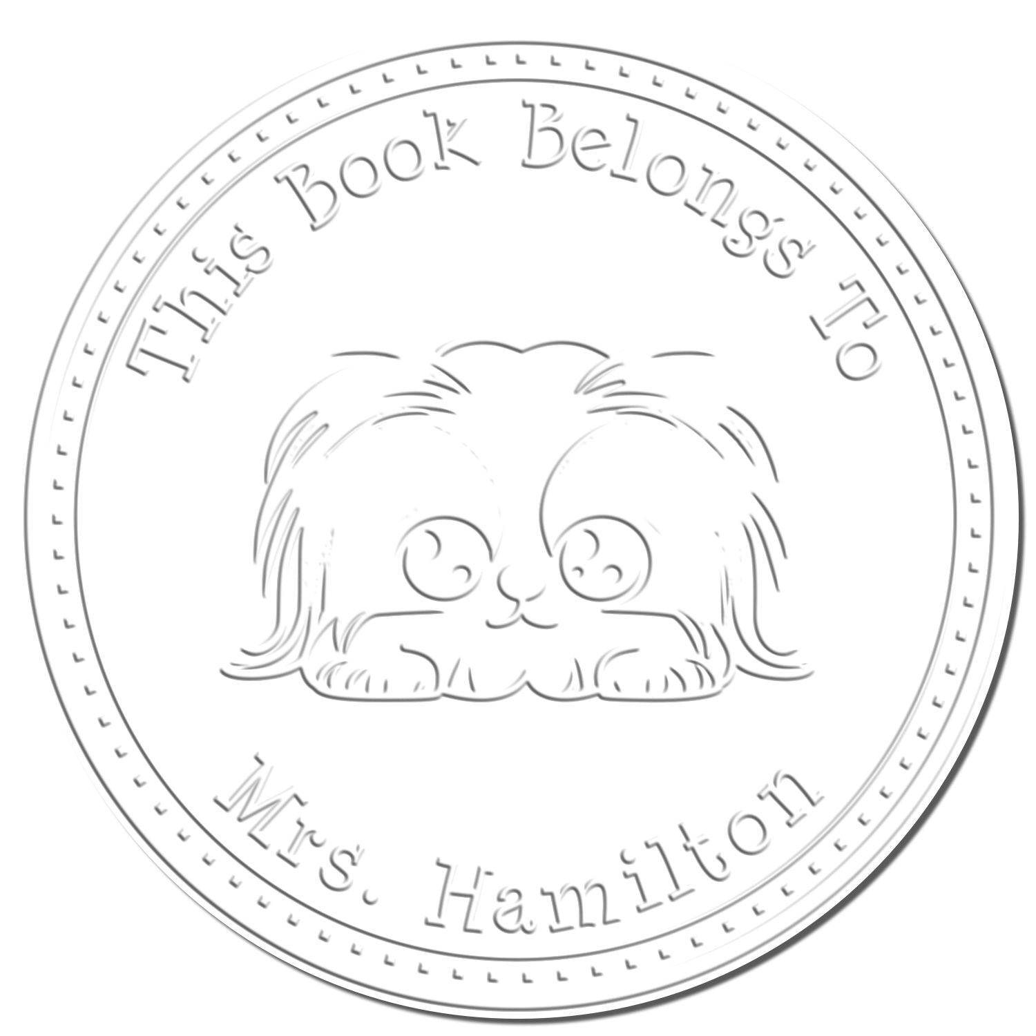 Circular gray embossed book stamp seal with a cute dog and text, This Book Belongs To Mrs. Hamilton.