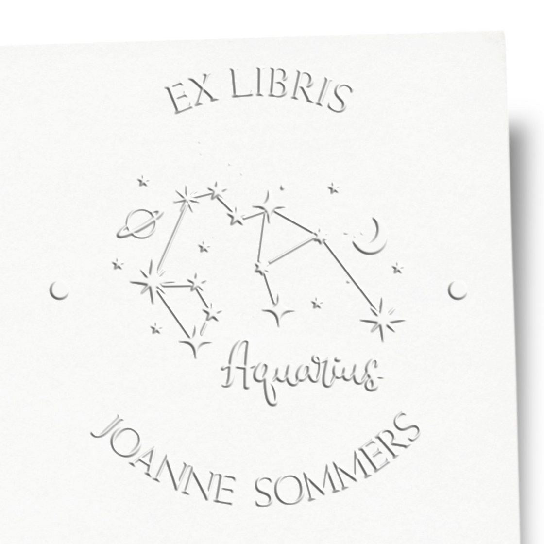 Shiny Aquarius constellation and celestial symbols custom embossed stamp in use, featuring planets, moon, and stars design.