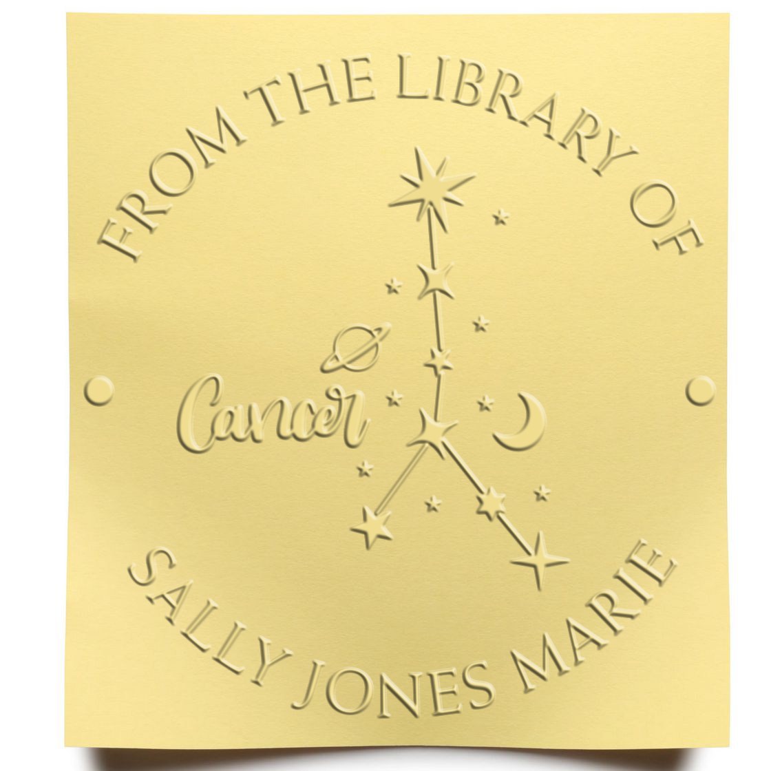 Gold embossed From the Library of Cancer stamp seal with stars and the name Sally Jones Marie.