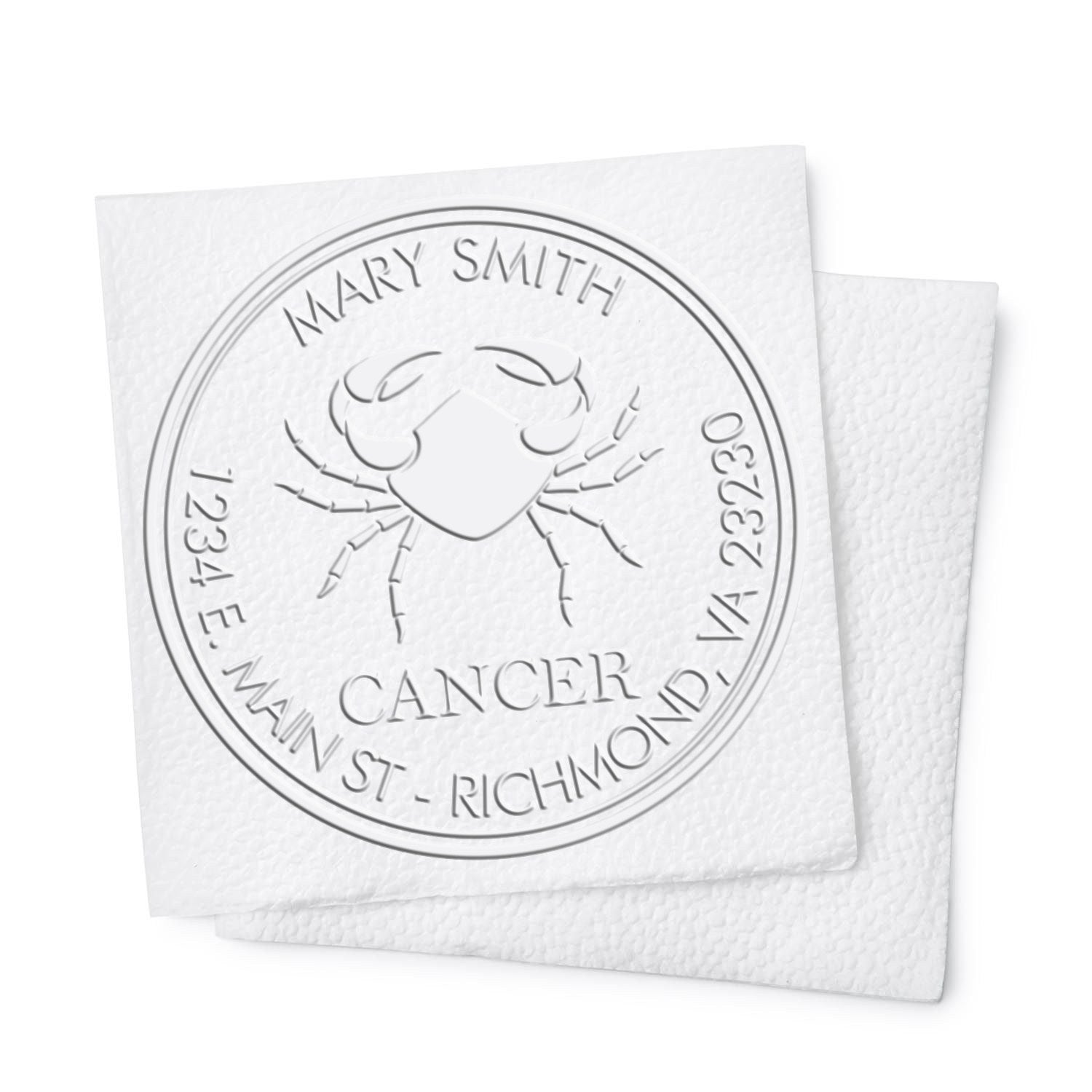 Embossed white cancer awareness stamp seal with crab emblem, Mary Smith name, and Richmond, VA details on textured paper.