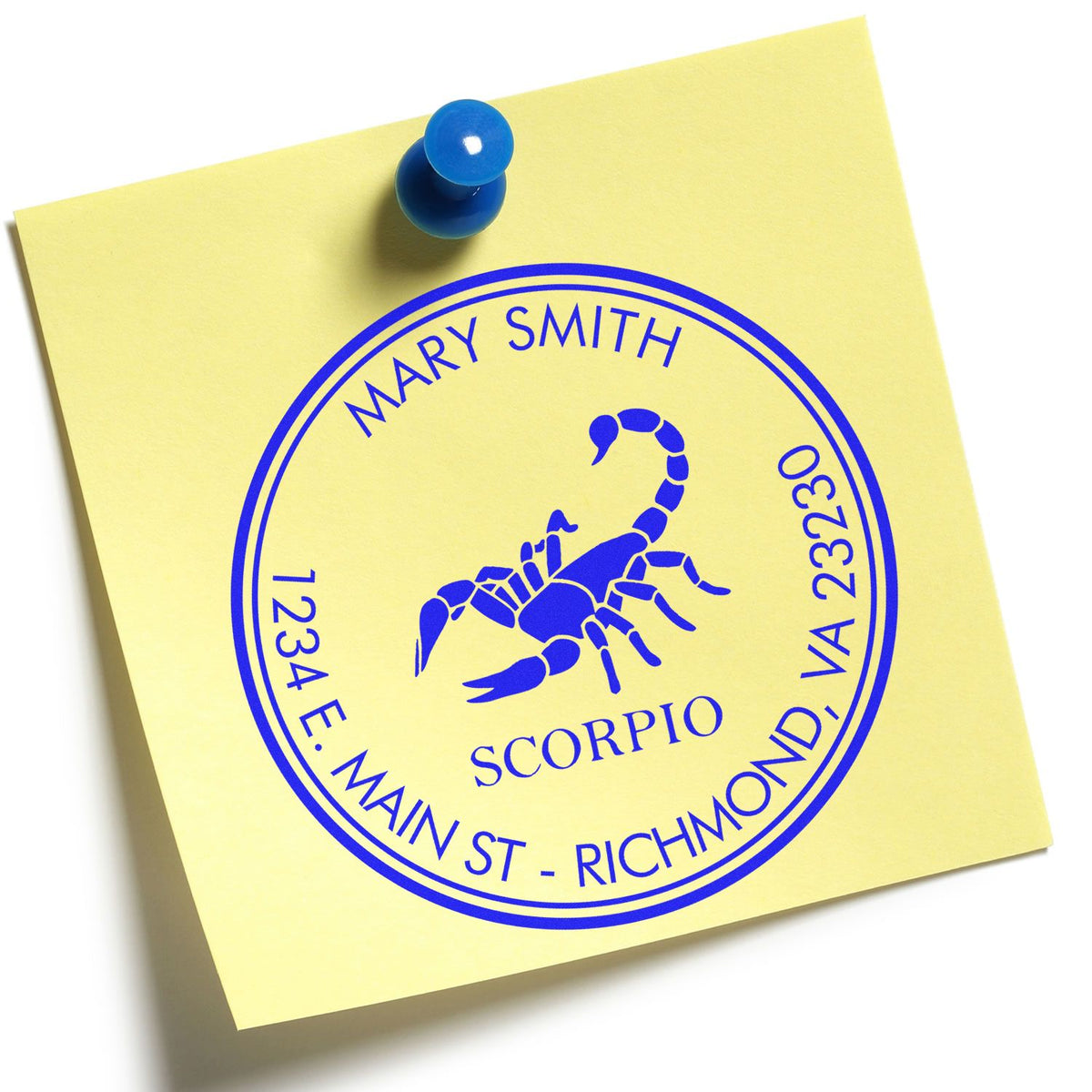 Yellow note with blue custom address stamp seal, Scorpio scorpion emblem, pinned with a blue pushpin.