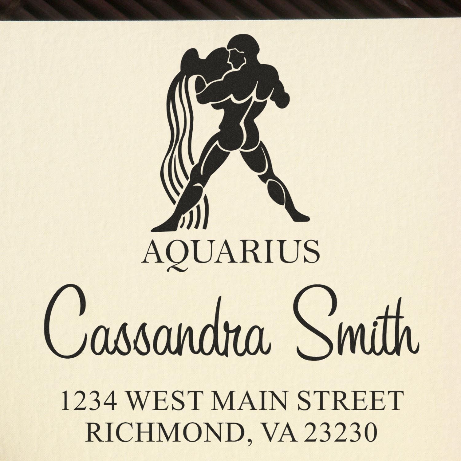 Black Aquarius stamp and seal with zodiac figure, Cassandra Smith name, and Richmond, VA address on cream background.