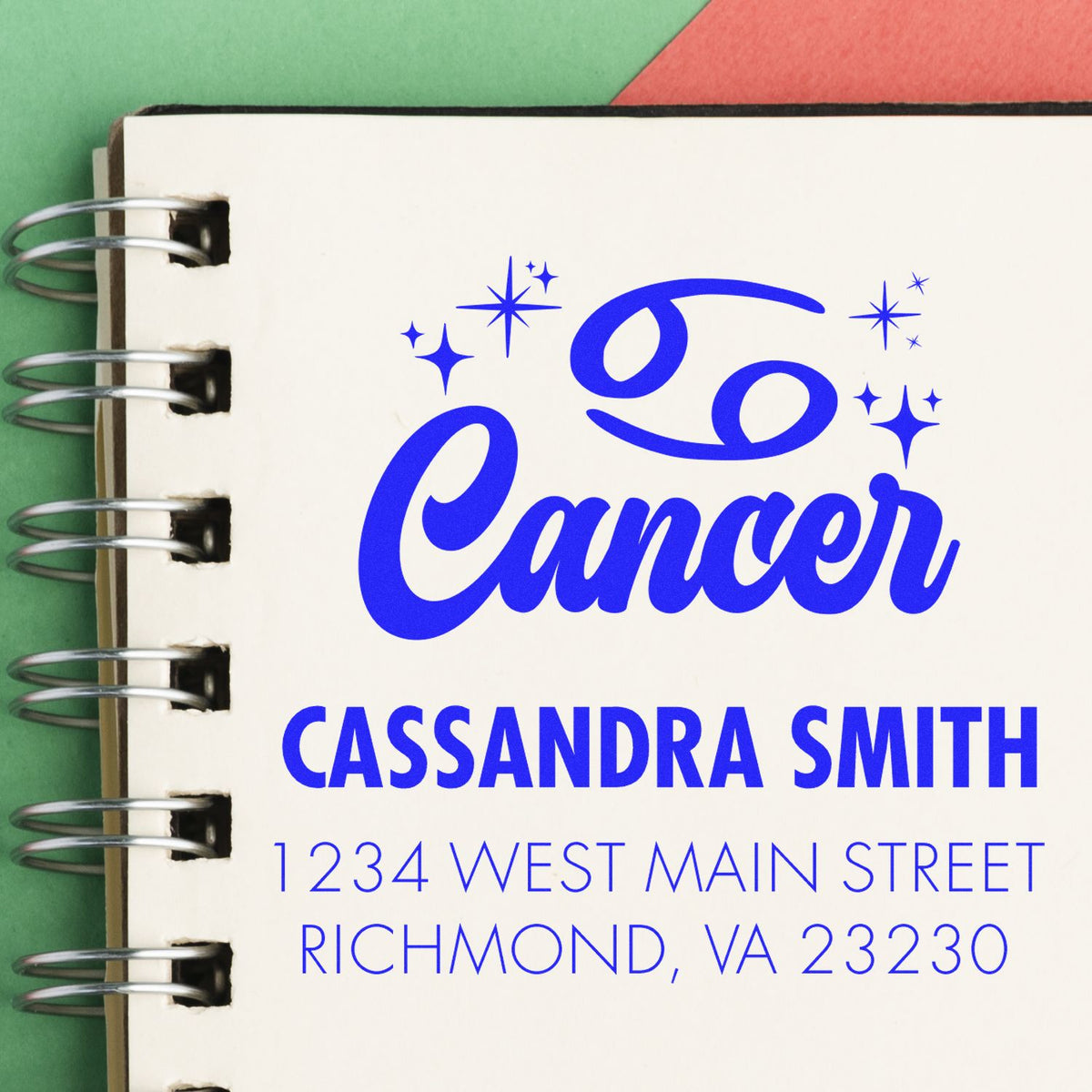Blue Cancer stamp seal on cream spiral notebook, personalized with Cassandra Smith and Richmond, VA address.