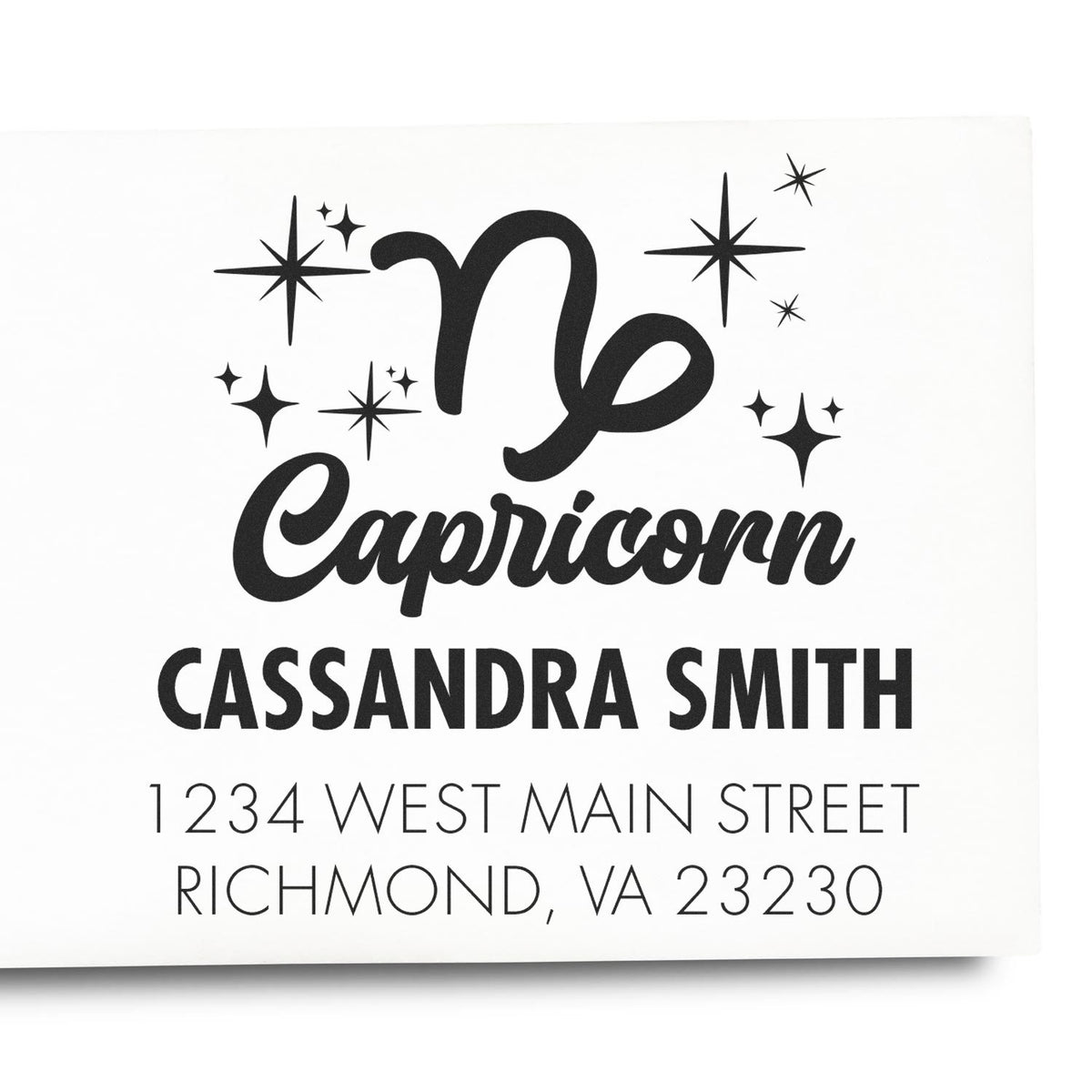 Custom black Capricorn rubber stamp with star accents, Cassandra Smith name and address on white background.