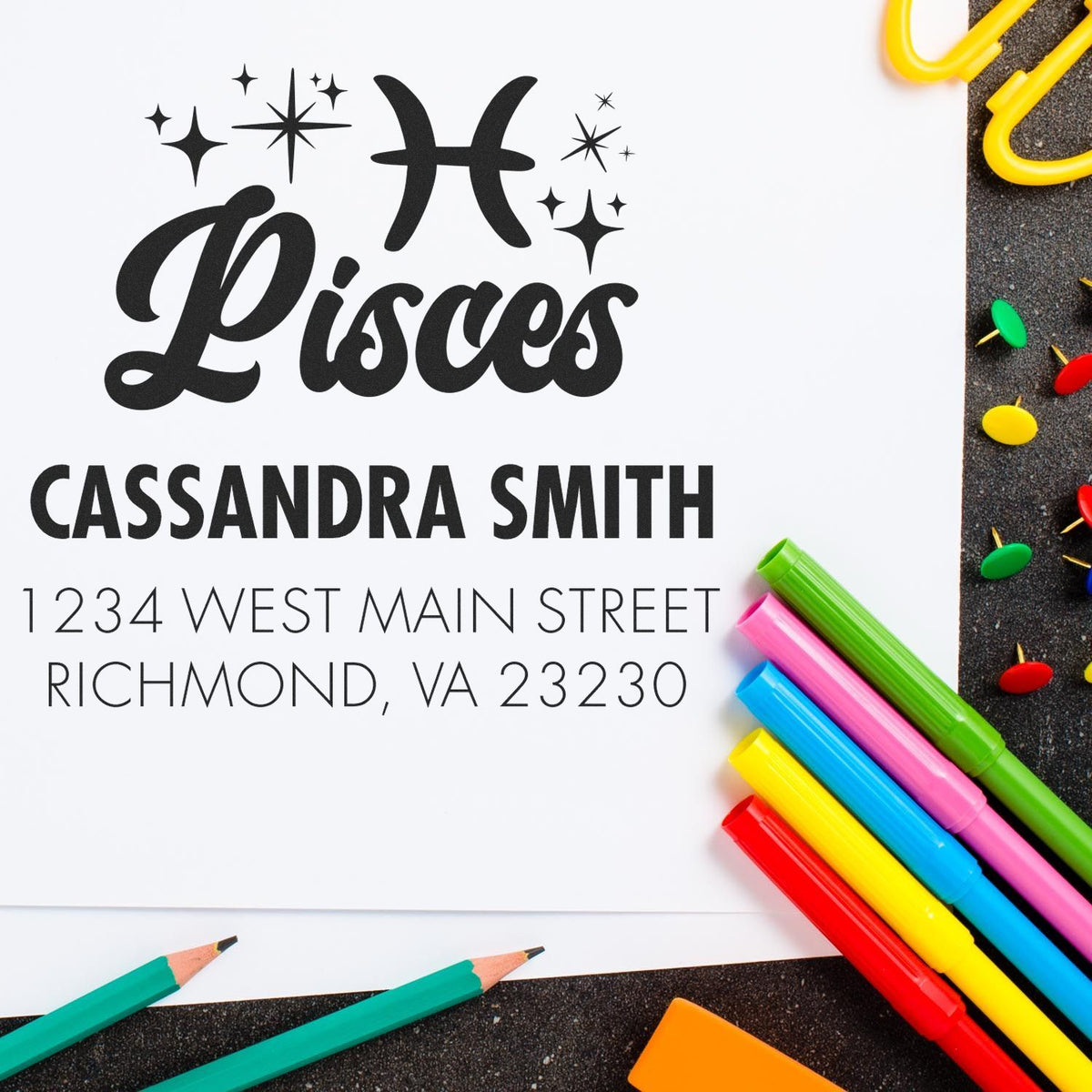 Black Pisces custom address stamp and seal with Cassandra Smith, Richmond VA, surrounded by colorful pens and pushpins.