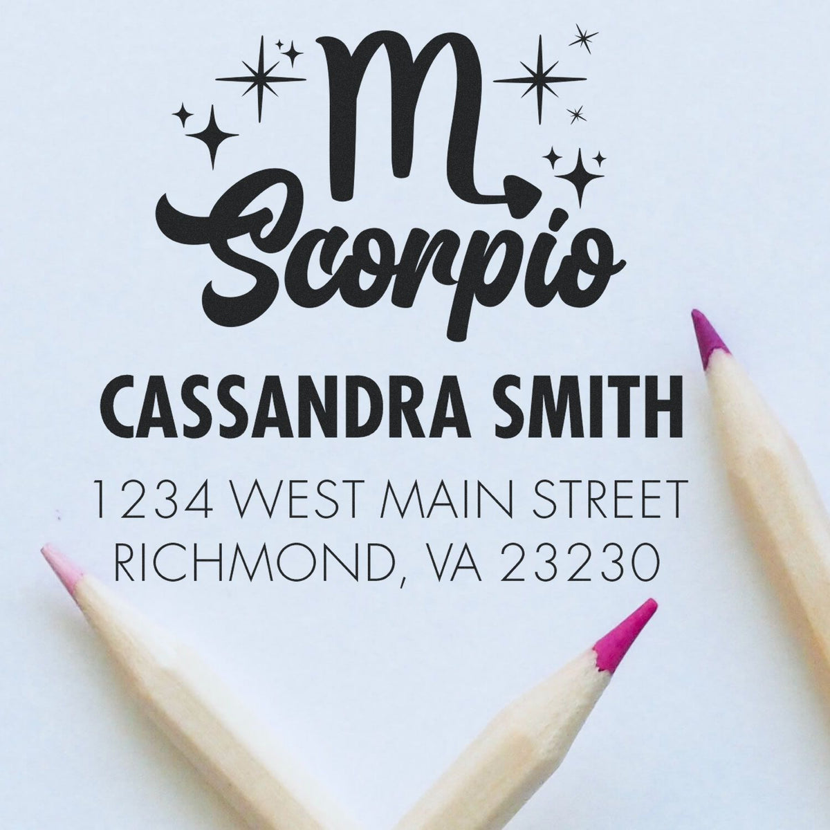 Custom Scorpio stamp seal in black on white, with star accents, Cassandra Smith name, and pink pencil tips.