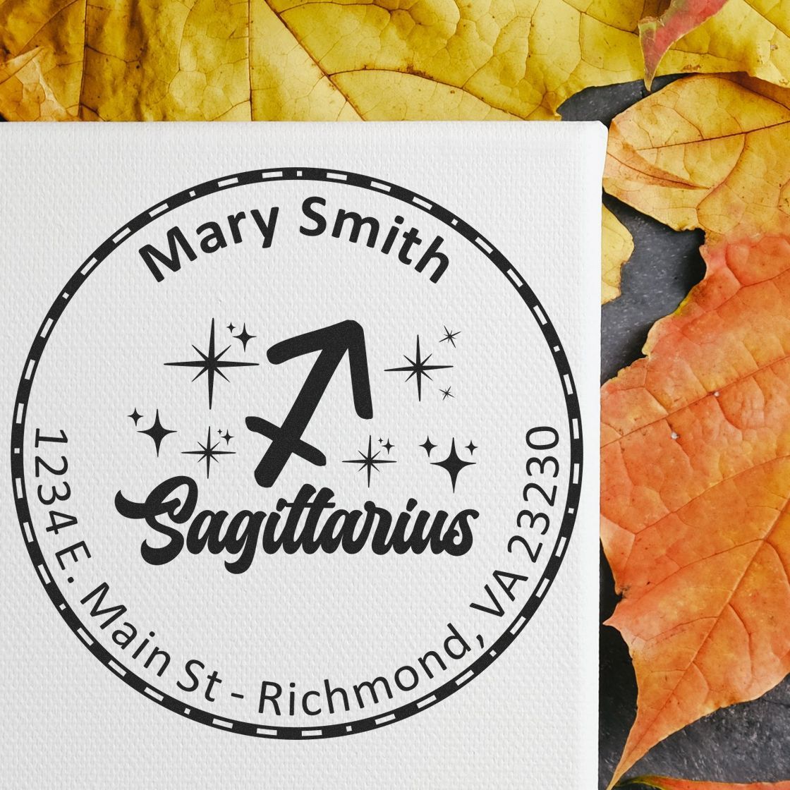 Custom black Sagittarius stamp seal for Mary Smith on white cardstock, with stars and orange-yellow autumn leaves.