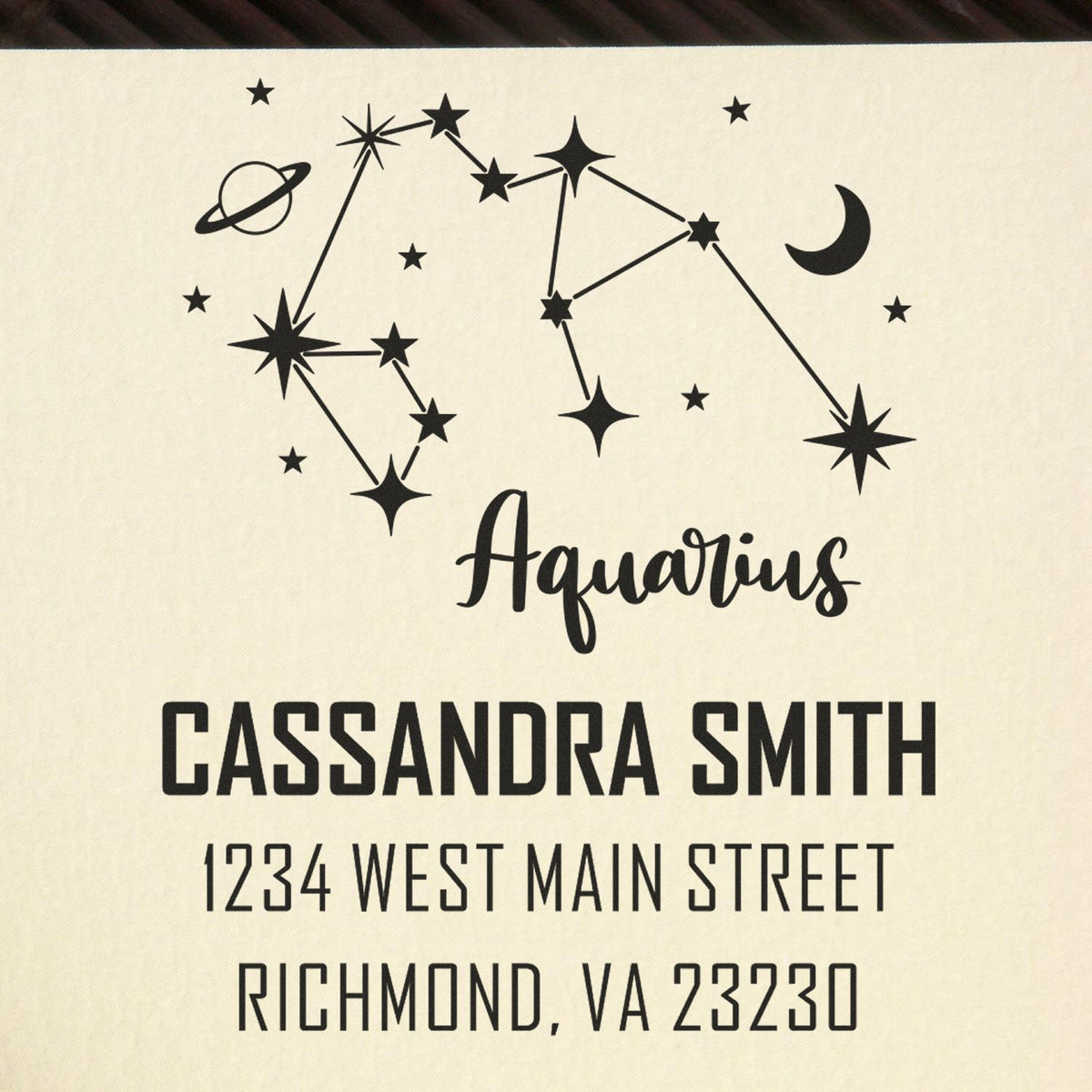 Black Aquarius constellation return address stamp on cream background with Cassandra Smith and Richmond, VA 23230.