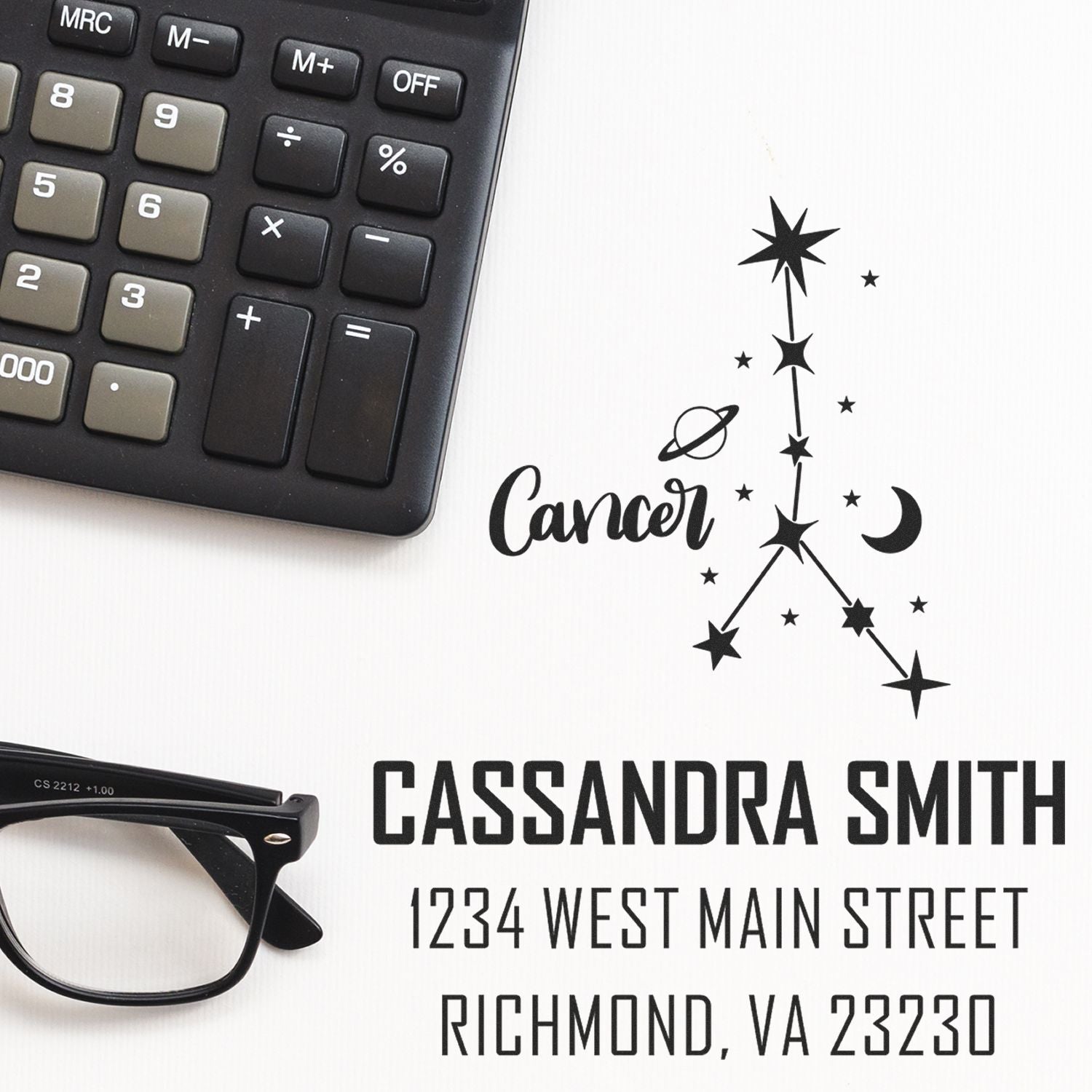 Black custom stamp and seal design with Cancer constellation, name, address, calculator, and eyeglasses on white background.