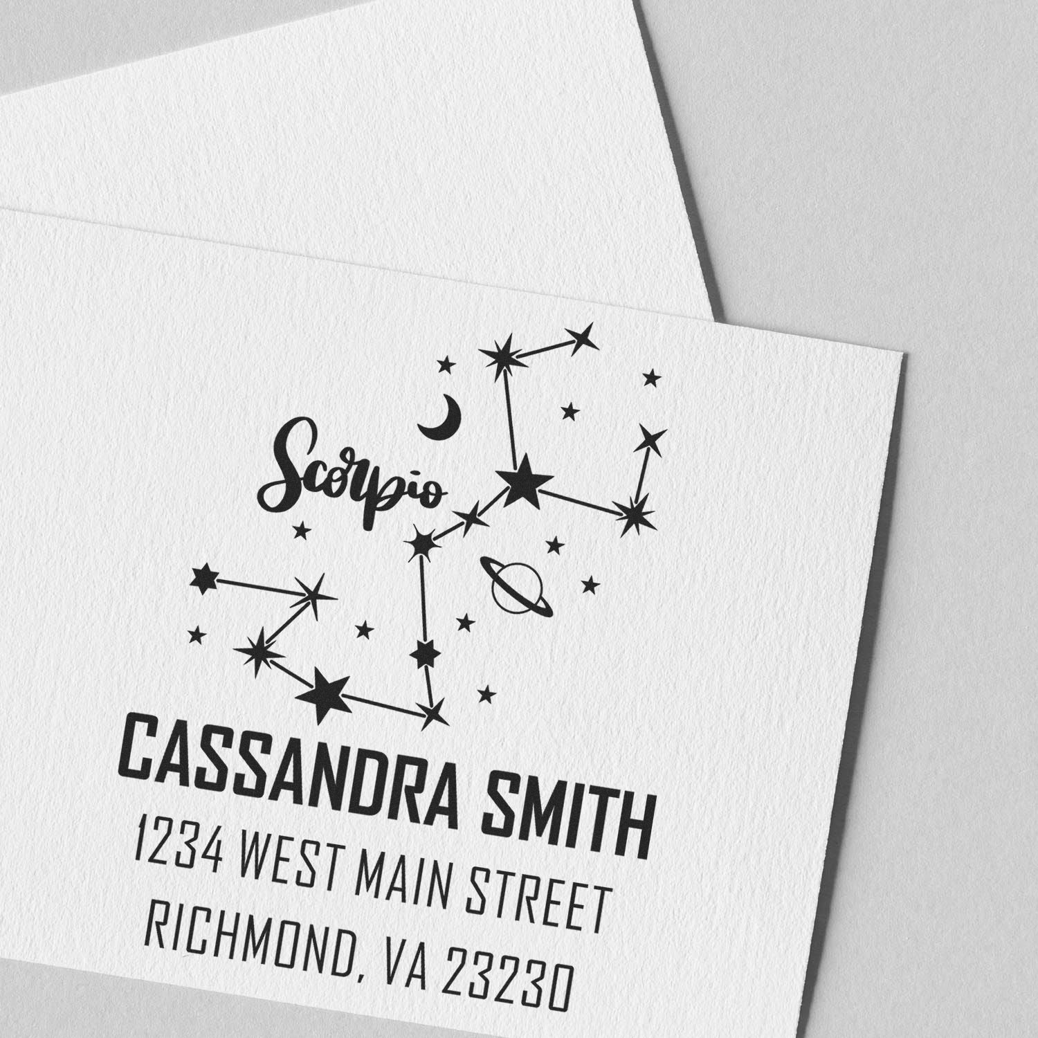 Black Scorpio constellation custom stamp and seal in black on white paper, with Cassandra Smith address details.