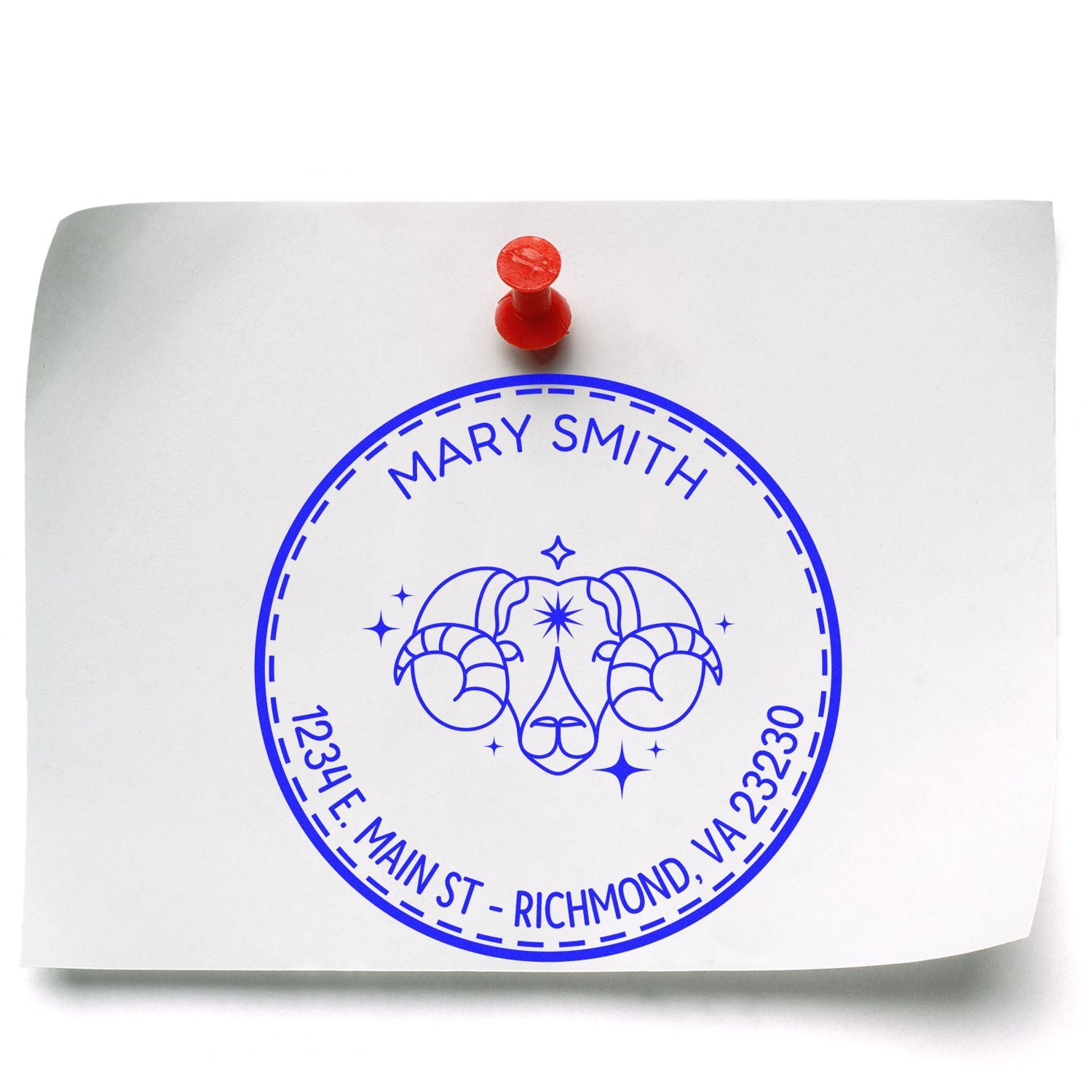 Custom blue round seal stamp for Mary Smith with ram graphic, pinned to white paper by a red tack.
