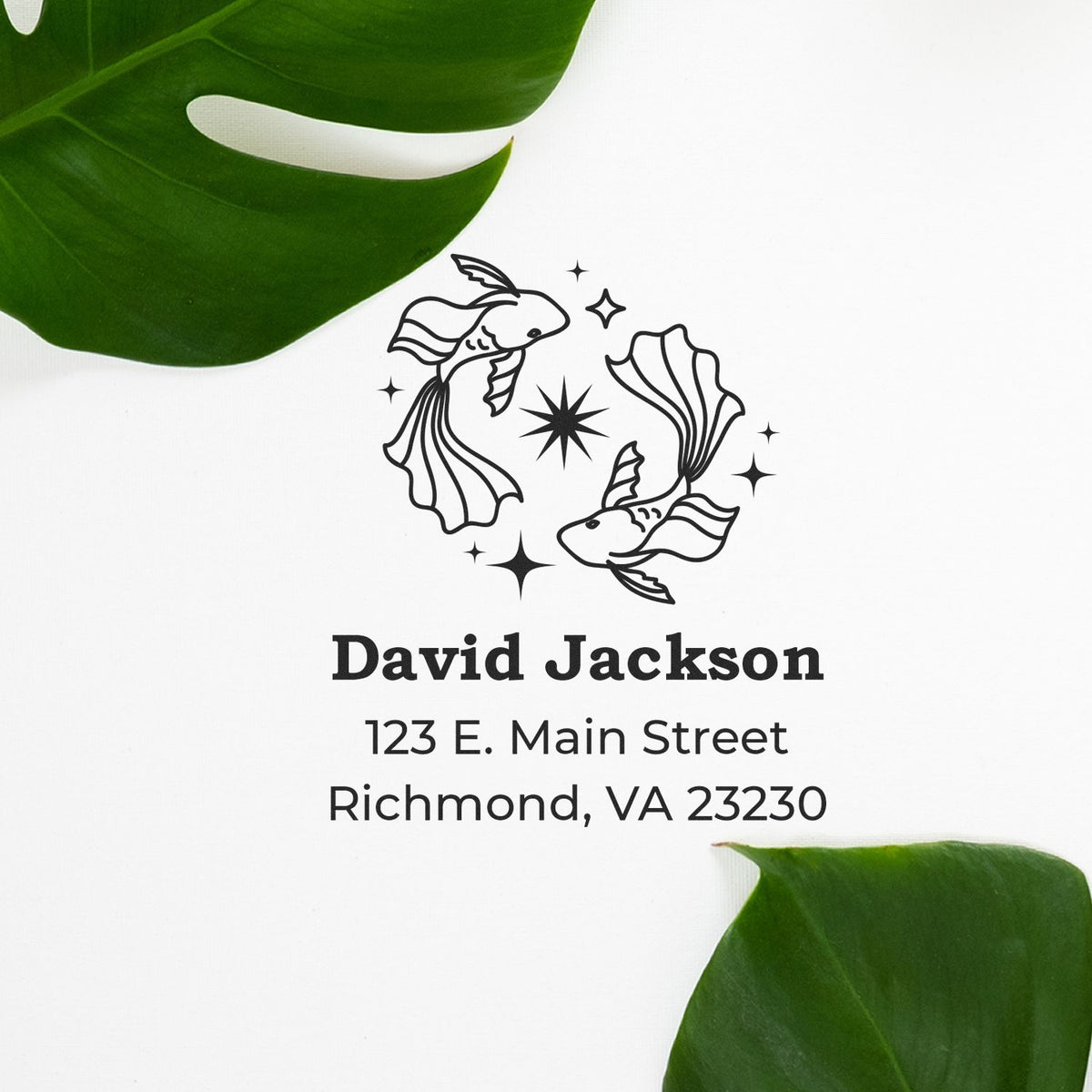 Custom black stamp and seal with two fish, sparkles, and David Jackson address on white background with green leaves