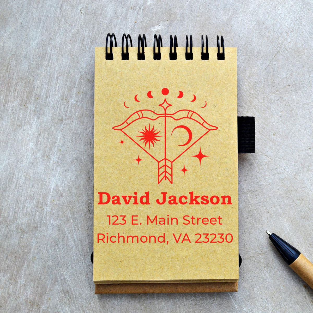 Custom stamp and seal notebook with red celestial logo, David Jackson address, and tan spiral-bound cover.