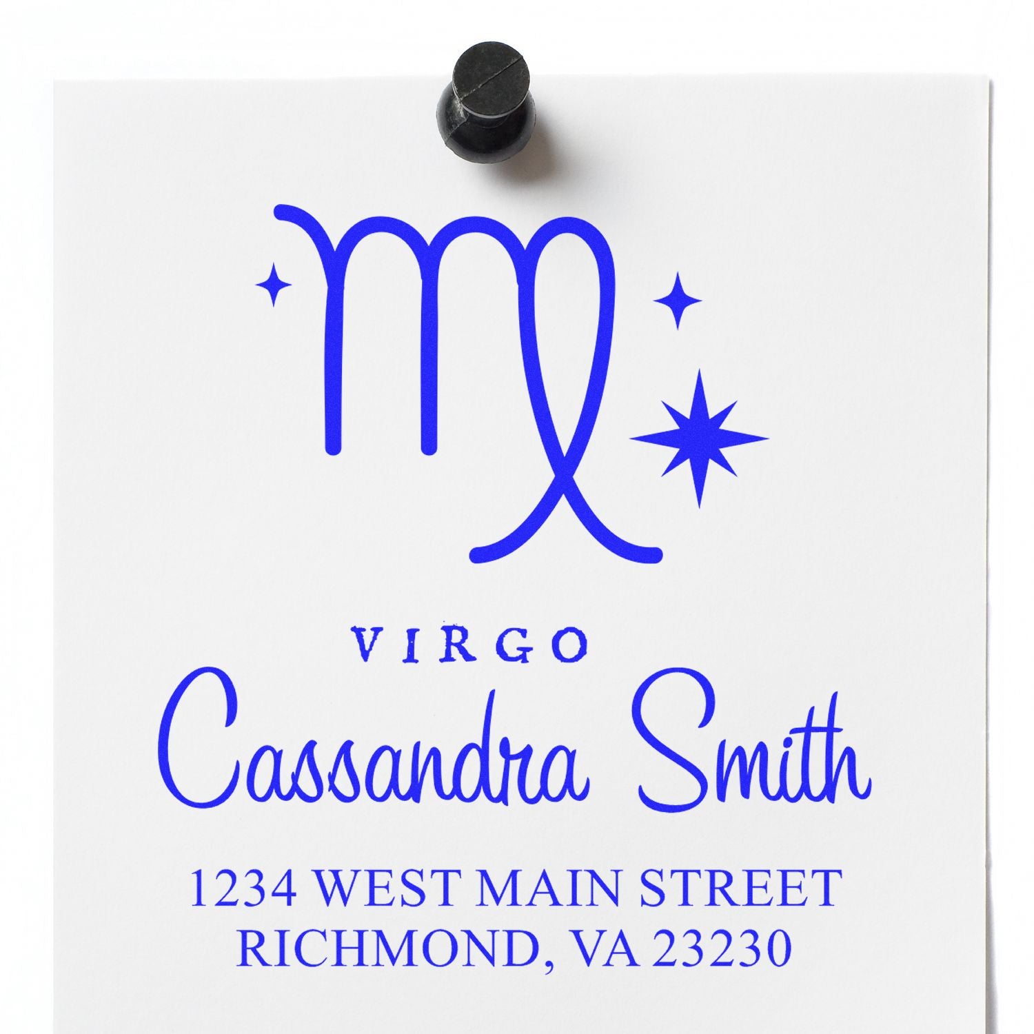 Blue Virgo custom address stamp on white paper with Cassandra Smith, Richmond, VA, and a black stamp handle at top.