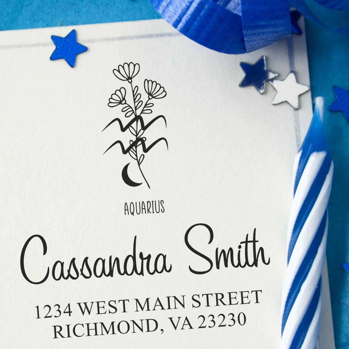 Aquarius address stamp with floral zodiac design in black on white paper, accented by blue ribbon and star seals.