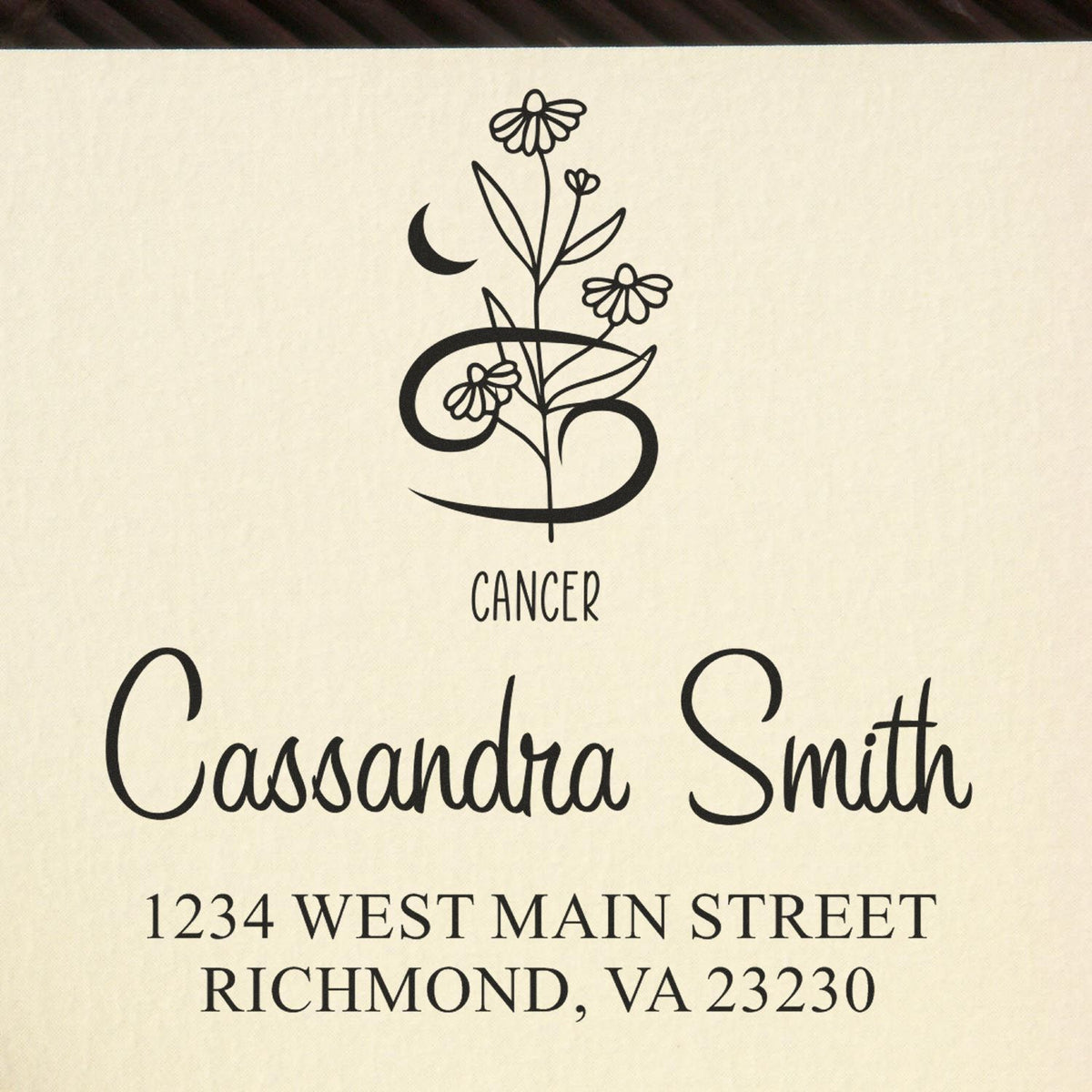 Black Cancer zodiac floral stamp seal with Cassandra Smith and Richmond, VA address on a cream background.