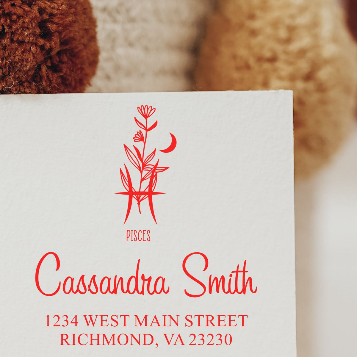 Red Pisces stamp and seal with floral zodiac icon, Cassandra Smith name, and Richmond, VA address on white paper.
