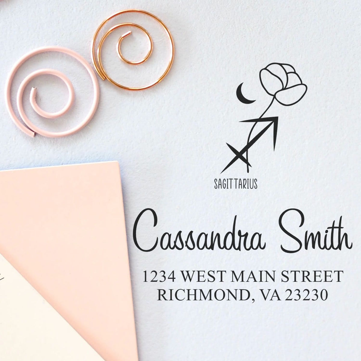 Personalized Sagittarius stamp and seal products with black lettering, rose gold and blush spiral accents, plus name and address.