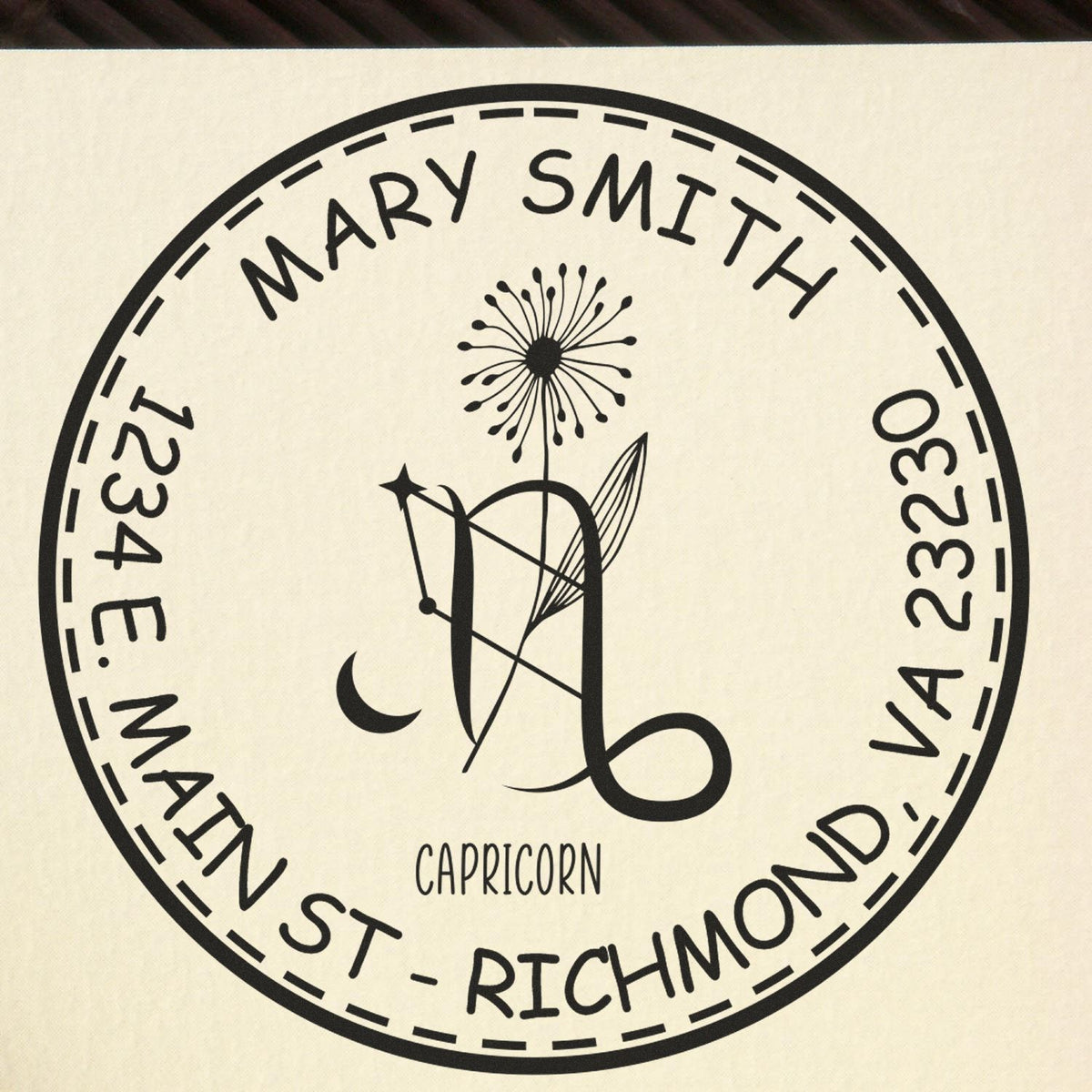 Black circular personal stamp seal for Mary Smith, Capricorn, with 1234 E Main St, Richmond VA 23230 on cream background.