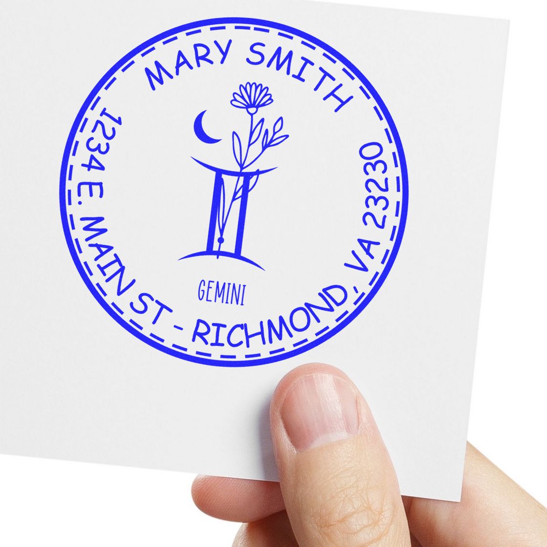 Blue circular Gemini address stamp seal with Mary Smith and Richmond text, moon-and-flower emblem on white card.