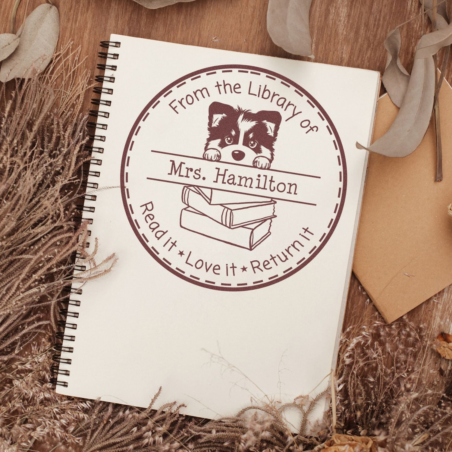 Burgundy custom library return stamp seal for Mrs. Hamilton with puppy, books, and Read it Love it Return it text.