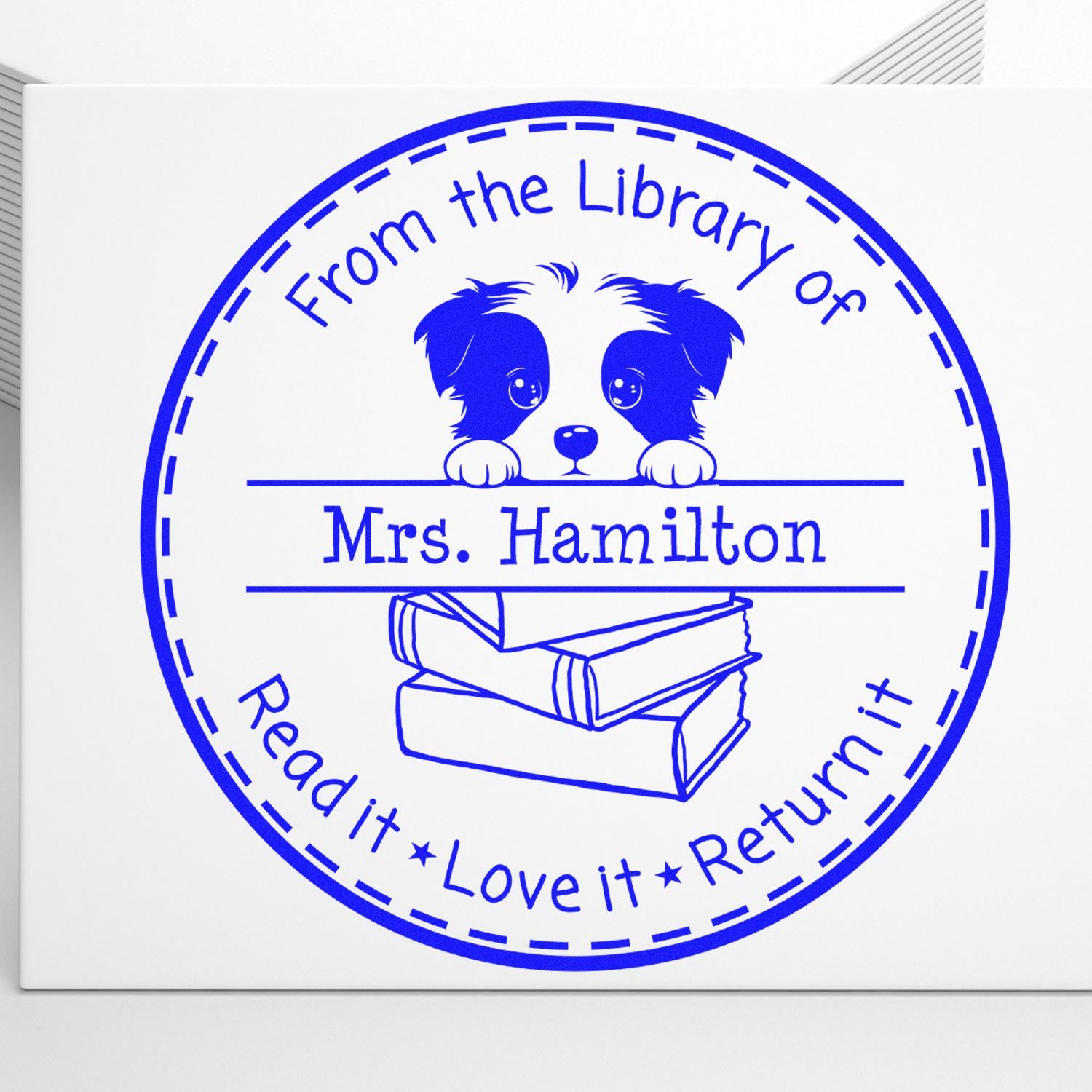 Blue circular library stamp seal with dog and books, reading From the Library of Mrs. HamiltonRead it, Love it, Return it.