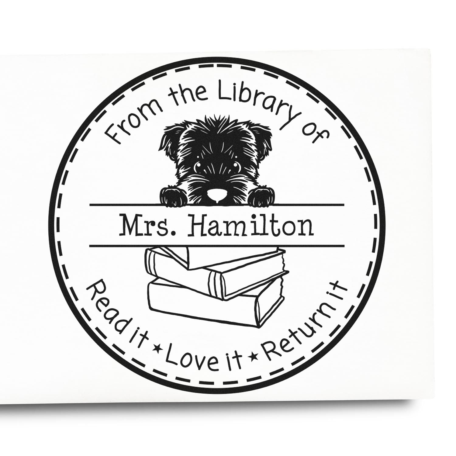 Black-and-white circular library stamp seal with puppy, books, and Mrs. Hamilton plus Read it, Love it, Return it text.