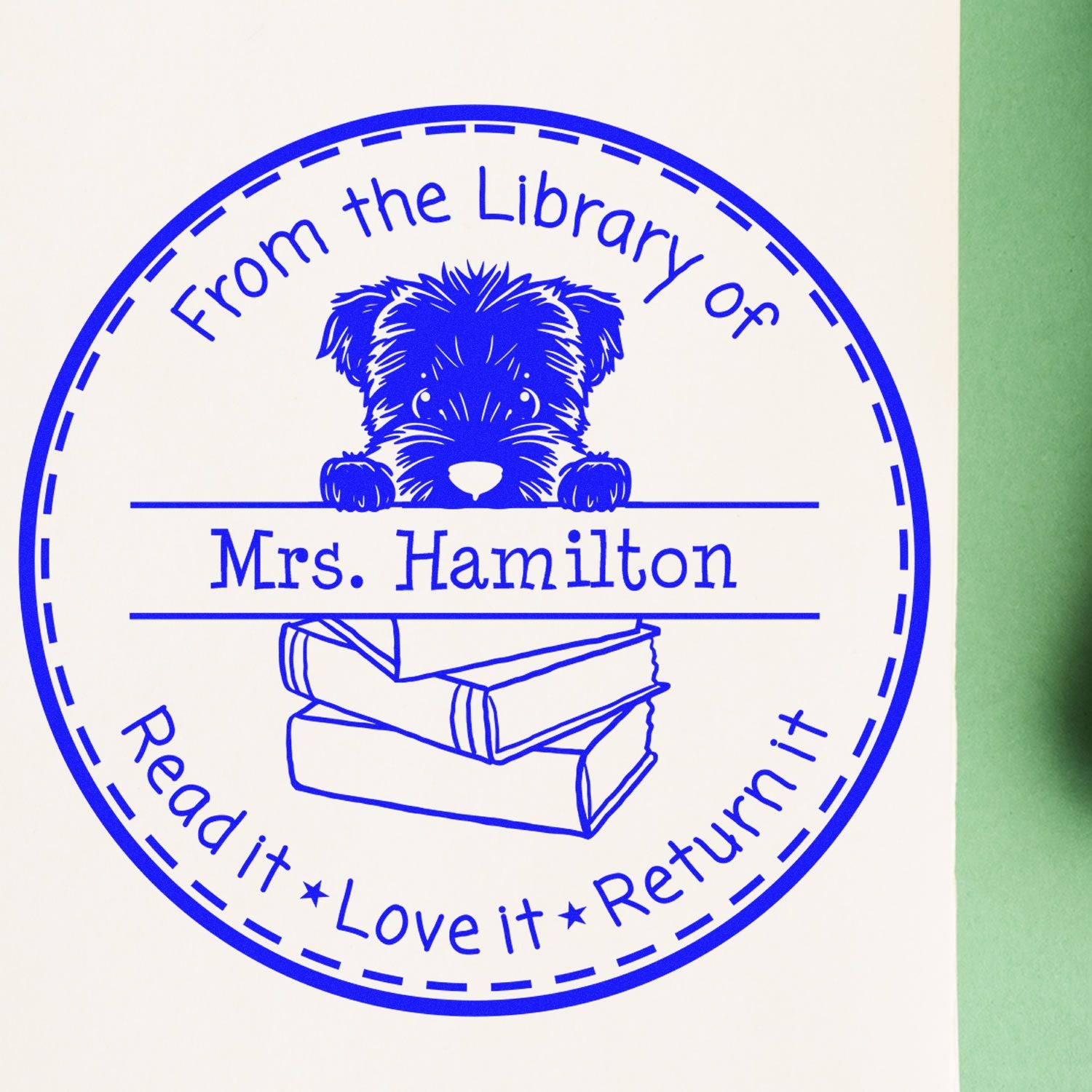 Blue circular library stamp seal with dog and books, reading From the Library of Mrs. Hamilton and Read it, Love it, Return it.