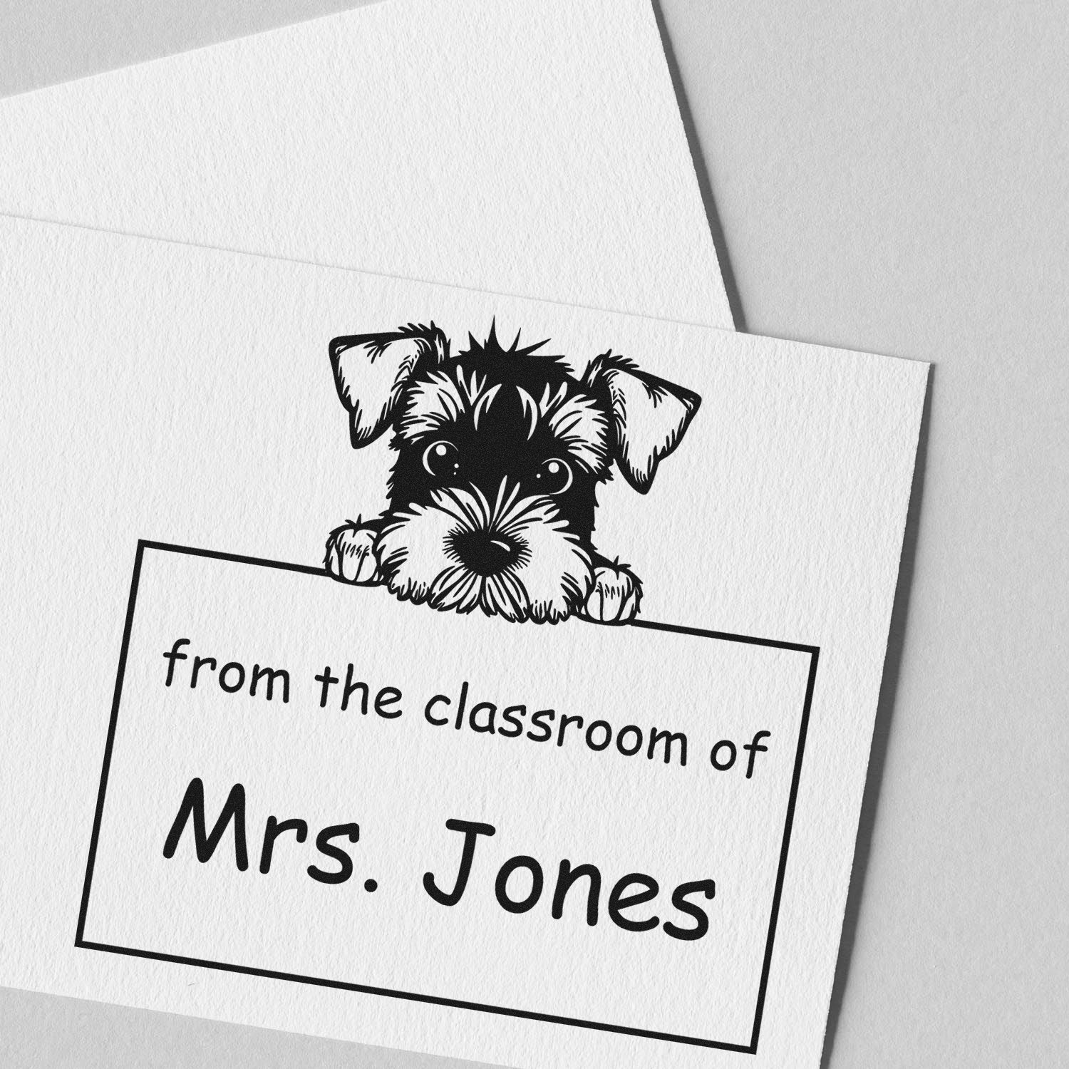 Black custom classroom stamp seal with a peeking schnauzer and text from the classroom of Mrs. Jones on white cardstock.