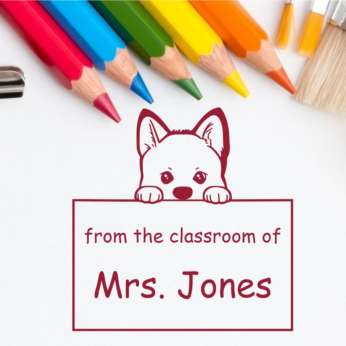 Custom classroom stamp seal with dog mascot and Mrs. Jones text, framed by colorful pencils and paint brushes.