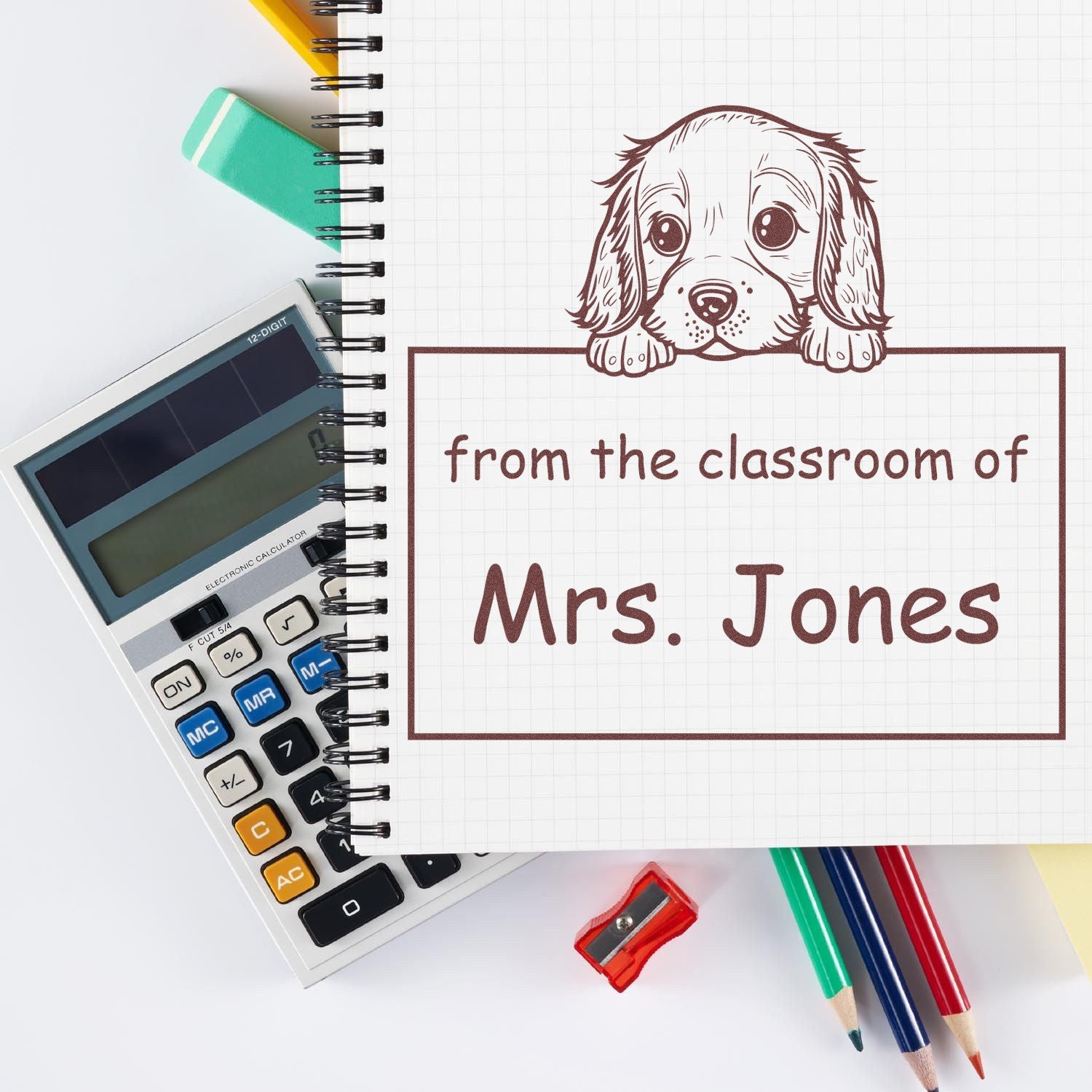 Brown puppy classroom stamp seal reading from the classroom of Mrs. Jones on graph paper with calculator and pencils.