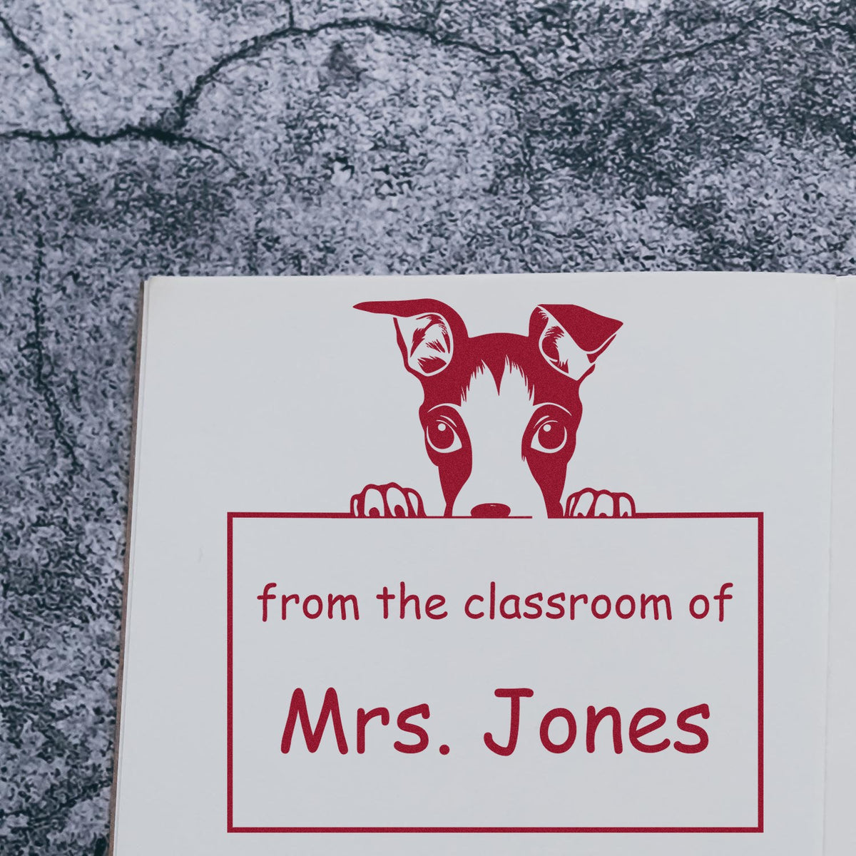 Custom red classroom stamp seal with peeking dog and from the classroom of Mrs. Jones on white card.