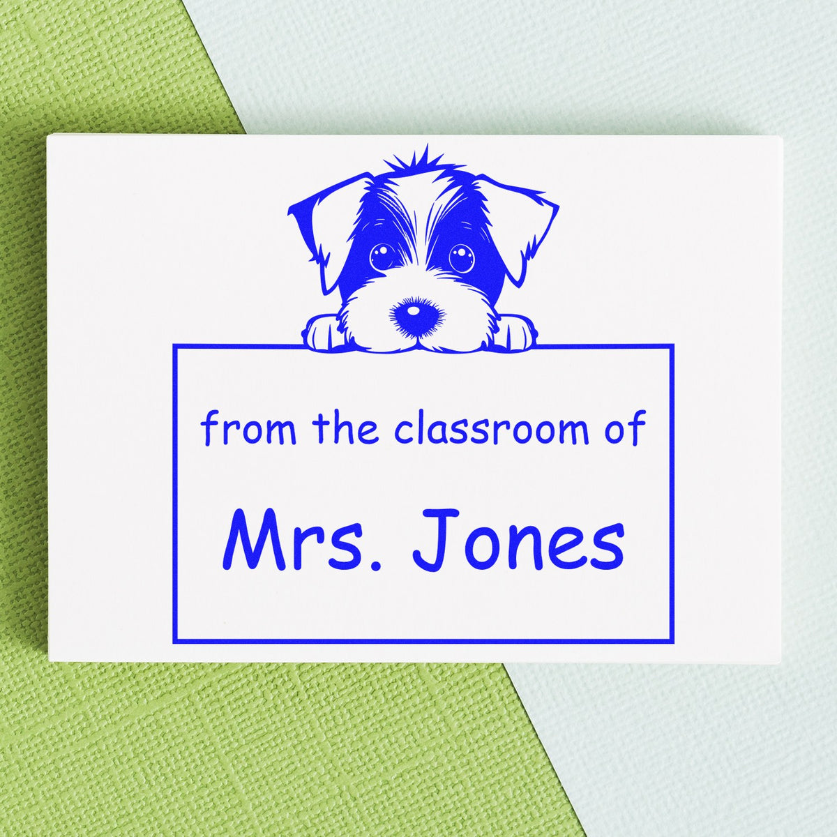 Blue custom classroom stamp seal with a dog peeking over a nameplate reading Mrs. Jones in bright blue on a white card.