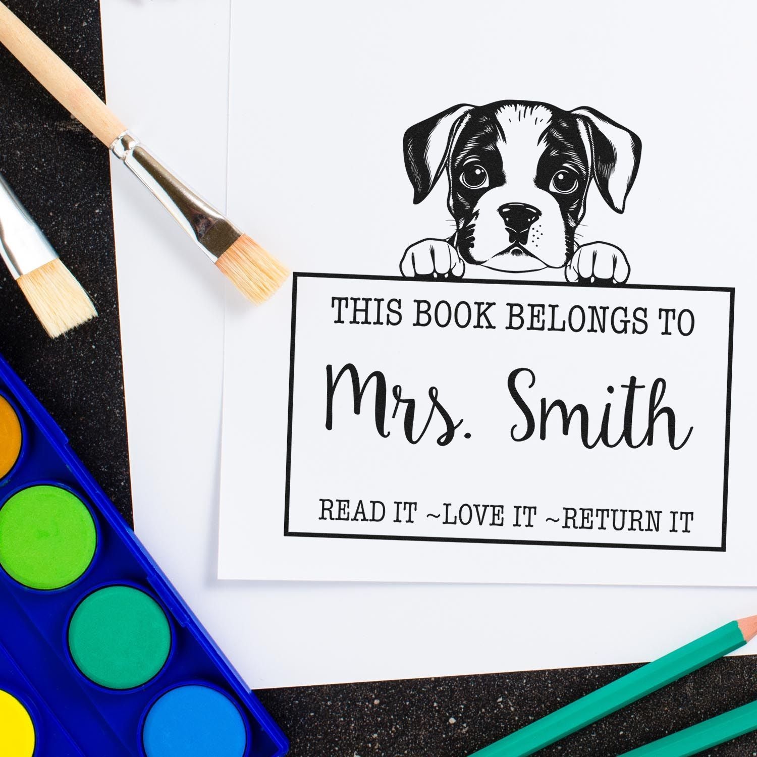Black-and-white dog bookplate stamp for Mrs. Smith, with This Book Belongs To and colorful paint supplies.