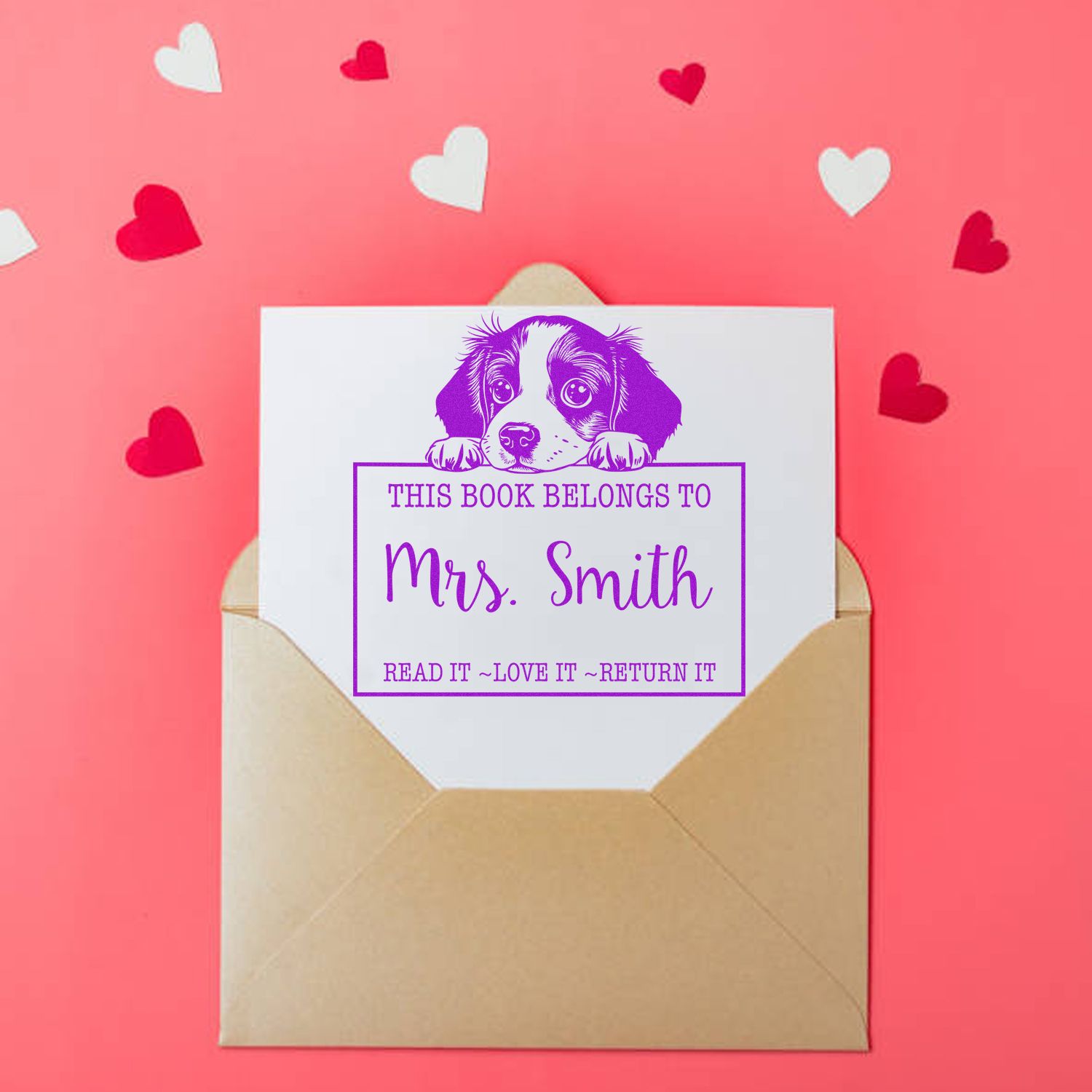 Purple puppy bookplate stamp and seal on white card in tan envelope, pink background with red and white hearts.