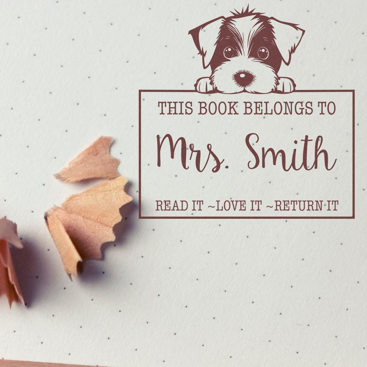 Maroon dog book ownership stamp with This book belongs to Mrs. Smith and Read it, love it, return it on white paper.