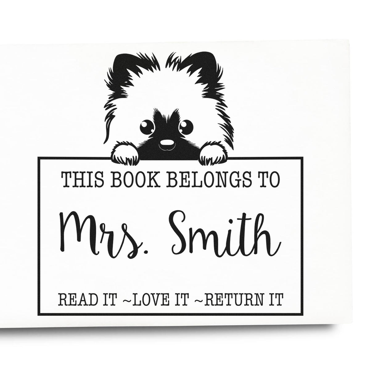 Black-and-white bookplate stamp with a cute dog peeking over a frame, This Book Belongs to Mrs. Smith, and Read it ~Love it ~Return it