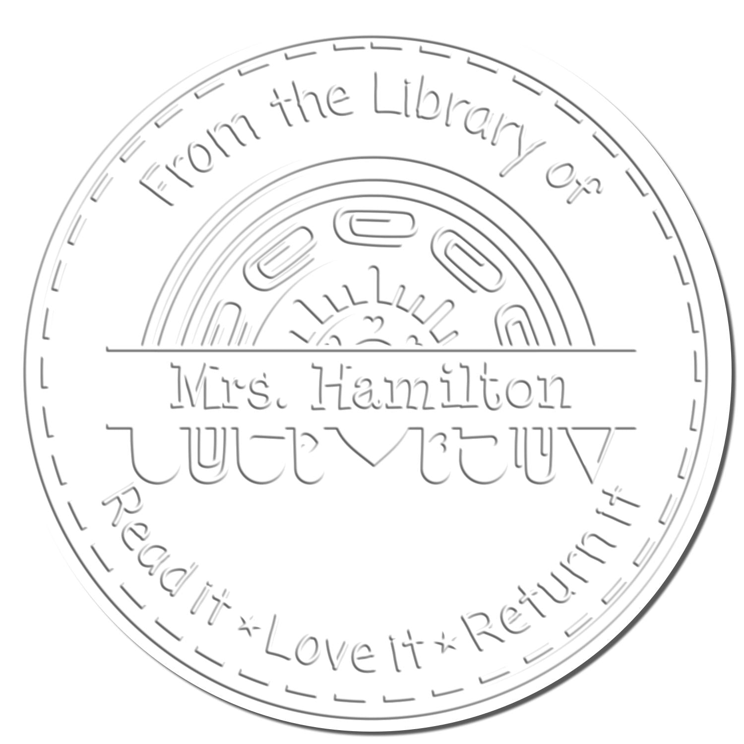 White embossed round library stamp seal with gray lettering: From the Library of Mrs. Hamilton and Read it Love it Return it.