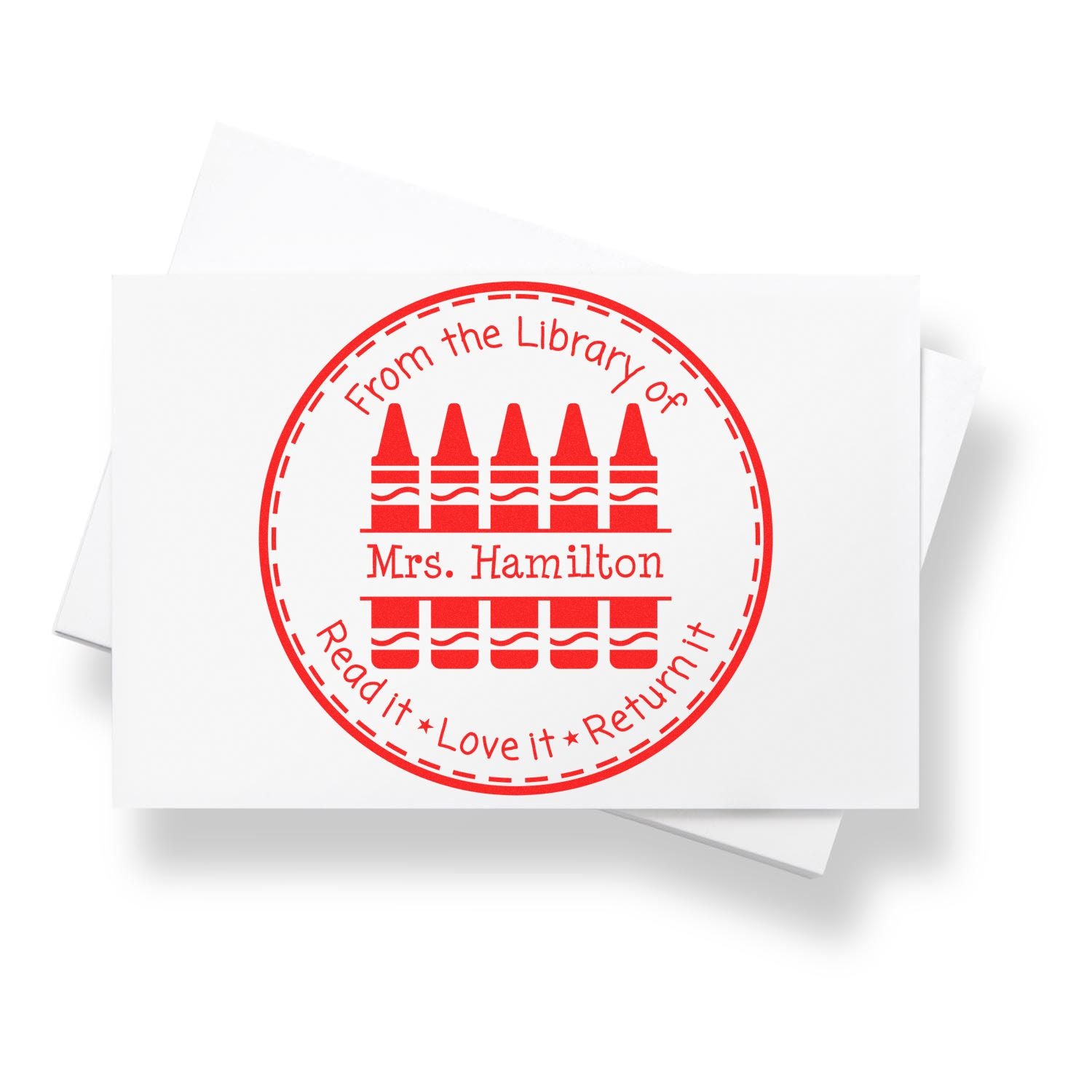 Red circular library stamp seal with books and text From the Library of Mrs. Hamilton Read it Love it Return it on white paper