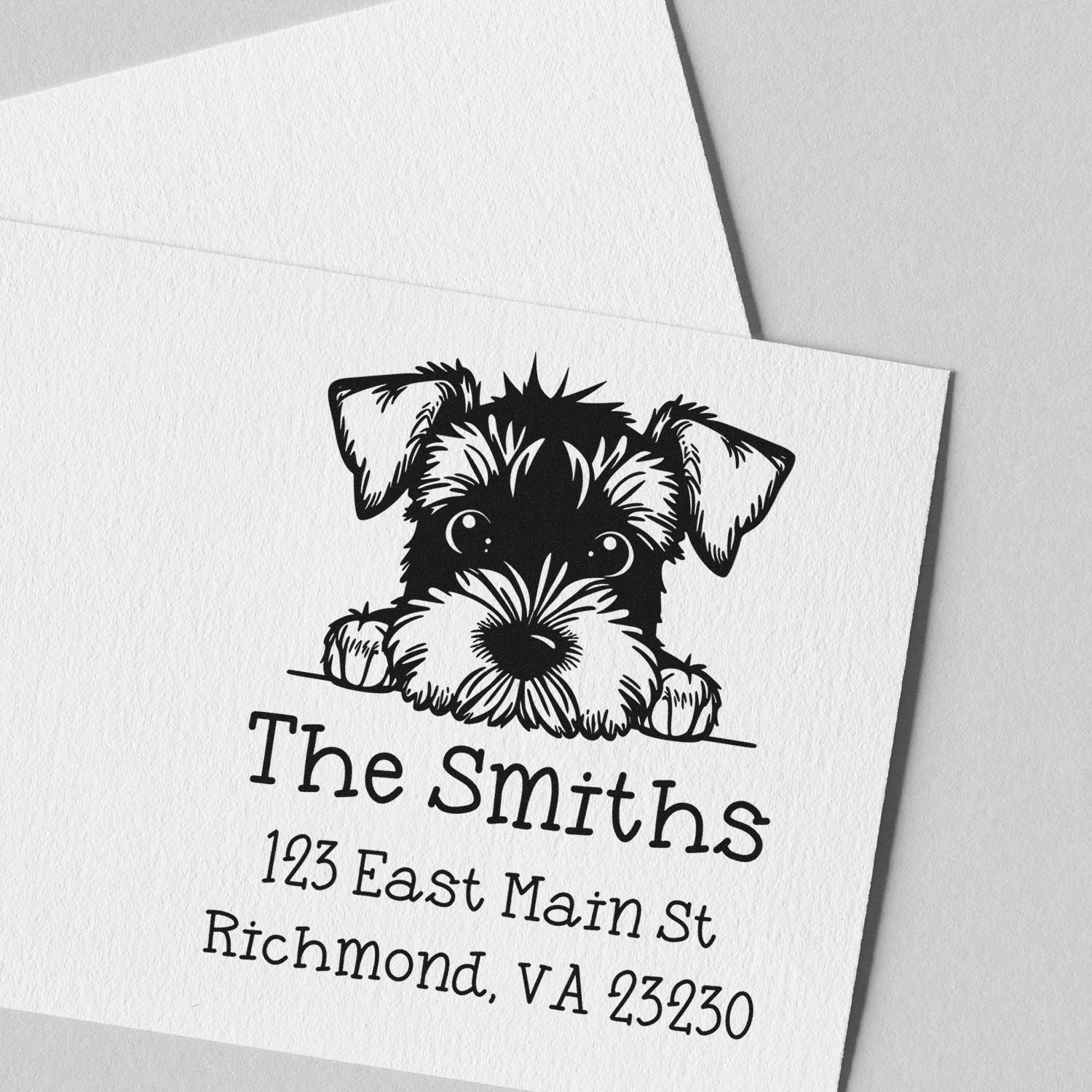 Black custom stamp and seal with playful dog illustration on white card, The Smiths, 123 East Main St, Richmond, VA 23230.