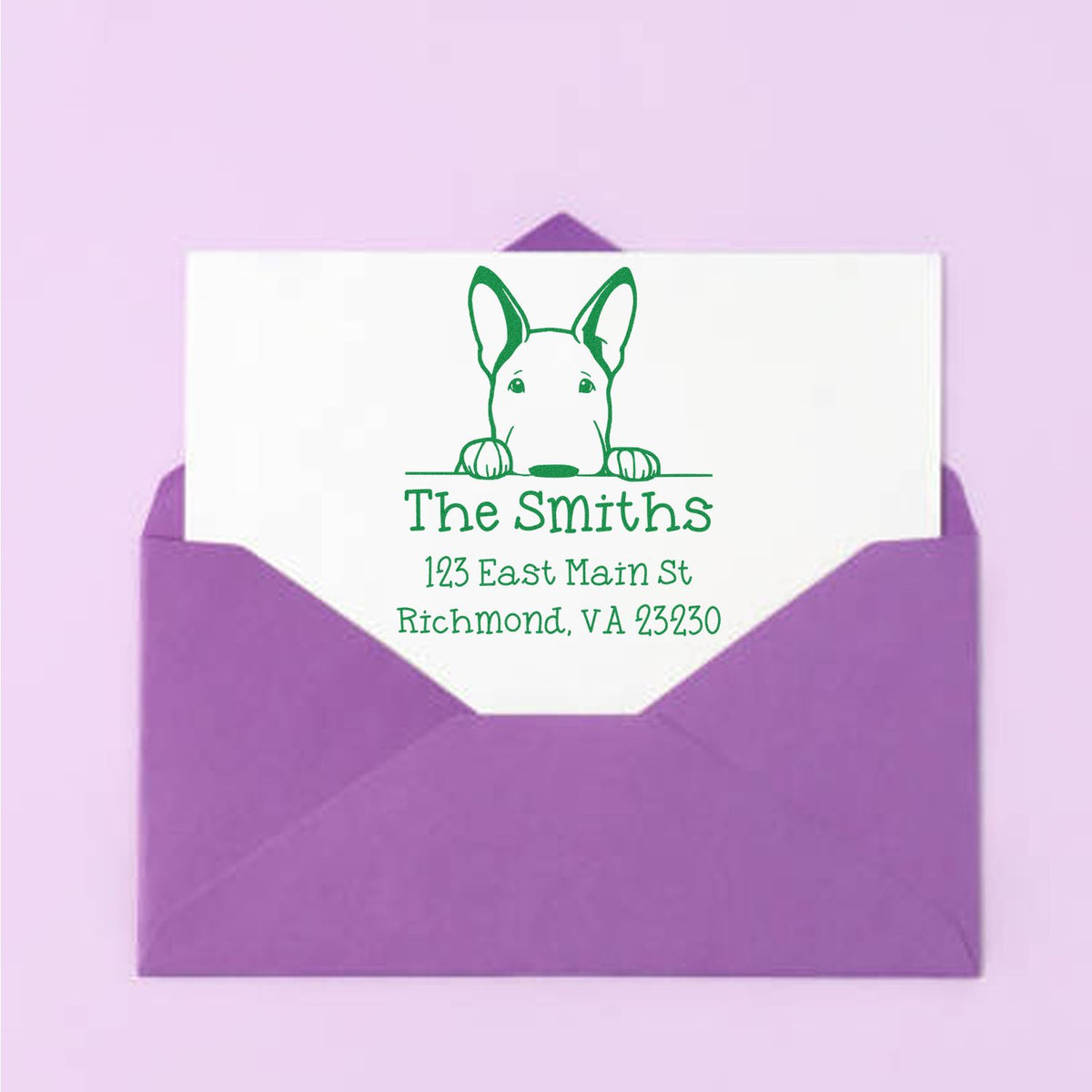 Purple envelope with white card and green custom return address stamp featuring a dog and The Smiths address.