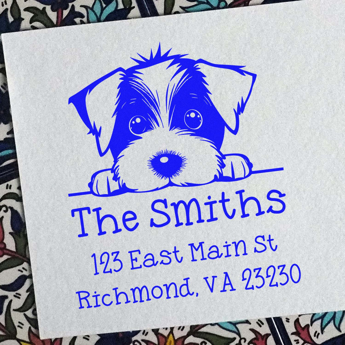 Blue custom stamp and seal with a puppy logo, The Smiths, and Richmond, VA address on white paper.