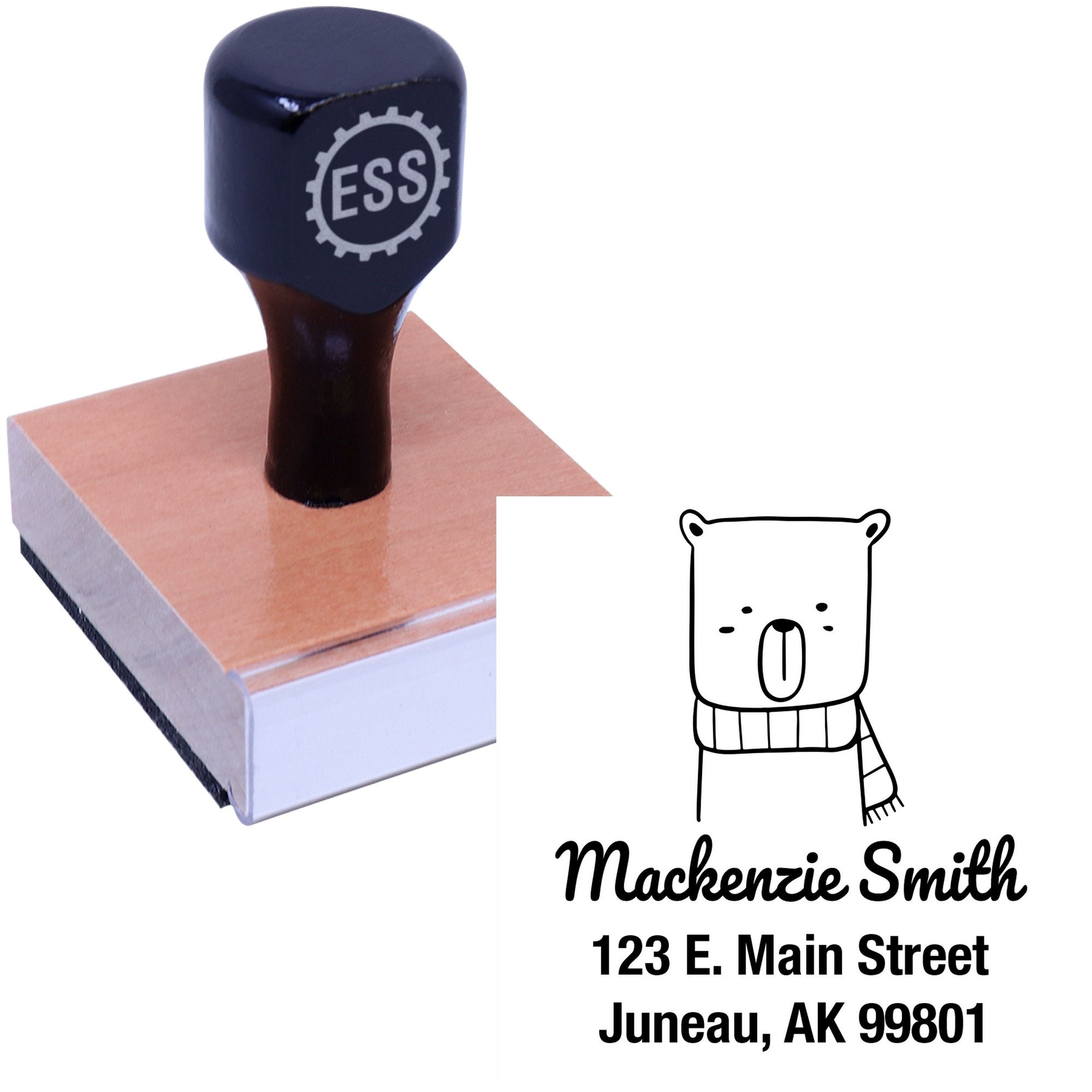 Wood handle mail stamper featuring a snuggly bear cartoon animal design. The personalized new address stamper displays "Mackenzie Smith, 123 E. Main Street, Juneau, AK 99801." Made to order with a wooden base and black top.