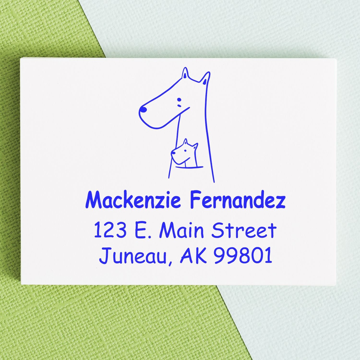 Wood handle snuggly kangaroos cartoon animal made to order home stamp on a card with blue ink. Custom-made home stamp features a kangaroo with a joey, personalized with name and address in blue text on a textured green and white background.